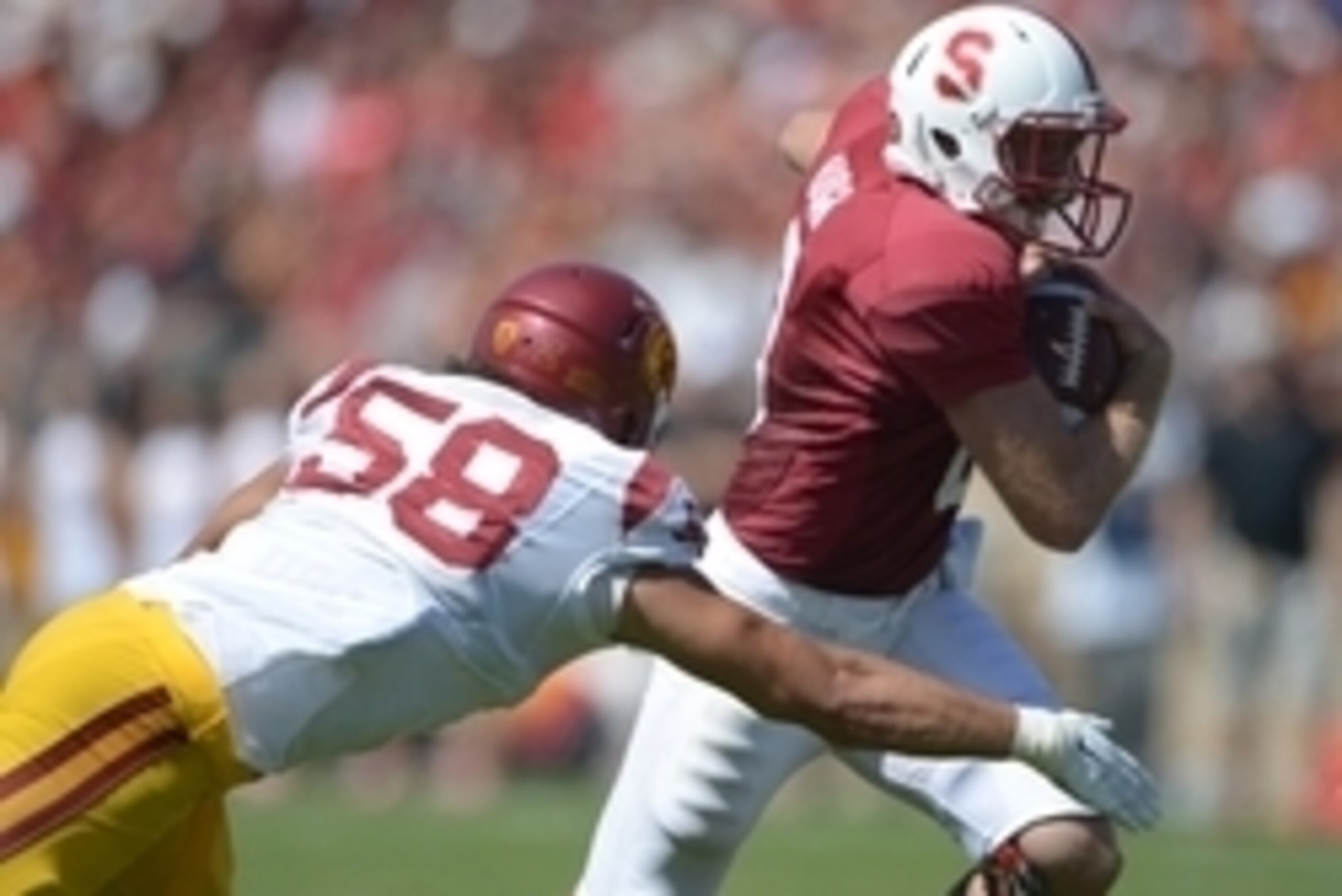 Sep 6, 2014; Stanford, CA, USA; Stanford Cardinal quarterback Kevin Hogan (8) is pursued by Southern California Trojans linebacker J.R. Tavai (58) at Stanford Stadium. USC defeated Stanford 13-10. Mandatory Credit: Kirby Lee-USA TODAY Sports