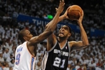 May 31, 2014; Oklahoma City, OK, USA; San Antonio Spurs forward Tim Duncan (21) attempts a shot against Oklahoma City Thunder forward Serge Ibaka (9) during the fourth quarter in game six of the Western Conference Finals of the 2014 NBA Playoffs at Chesap