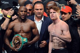 LAS VEGAS, NV - SEPTEMBER 13:  Golden Boy Promotions CEO Richard Schaefer (C) looks on as boxers Floyd Mayweather Jr. (L) and Canelo Alvarez (R) pose during the official weigh-in for their bout at the MGM Grand Garden Arena on September 13, 2013 in Las Ve