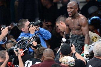 LAS VEGAS, NV - MAY 03:  Floyd Mayweather Jr. celebrates after defeating Marcos Maidana by majority decision in their WBC/WBA welterweight unification fight at the MGM Grand Garden Arena on May 3, 2014 in Las Vegas, Nevada.  (Photo by Ethan Miller/Getty I