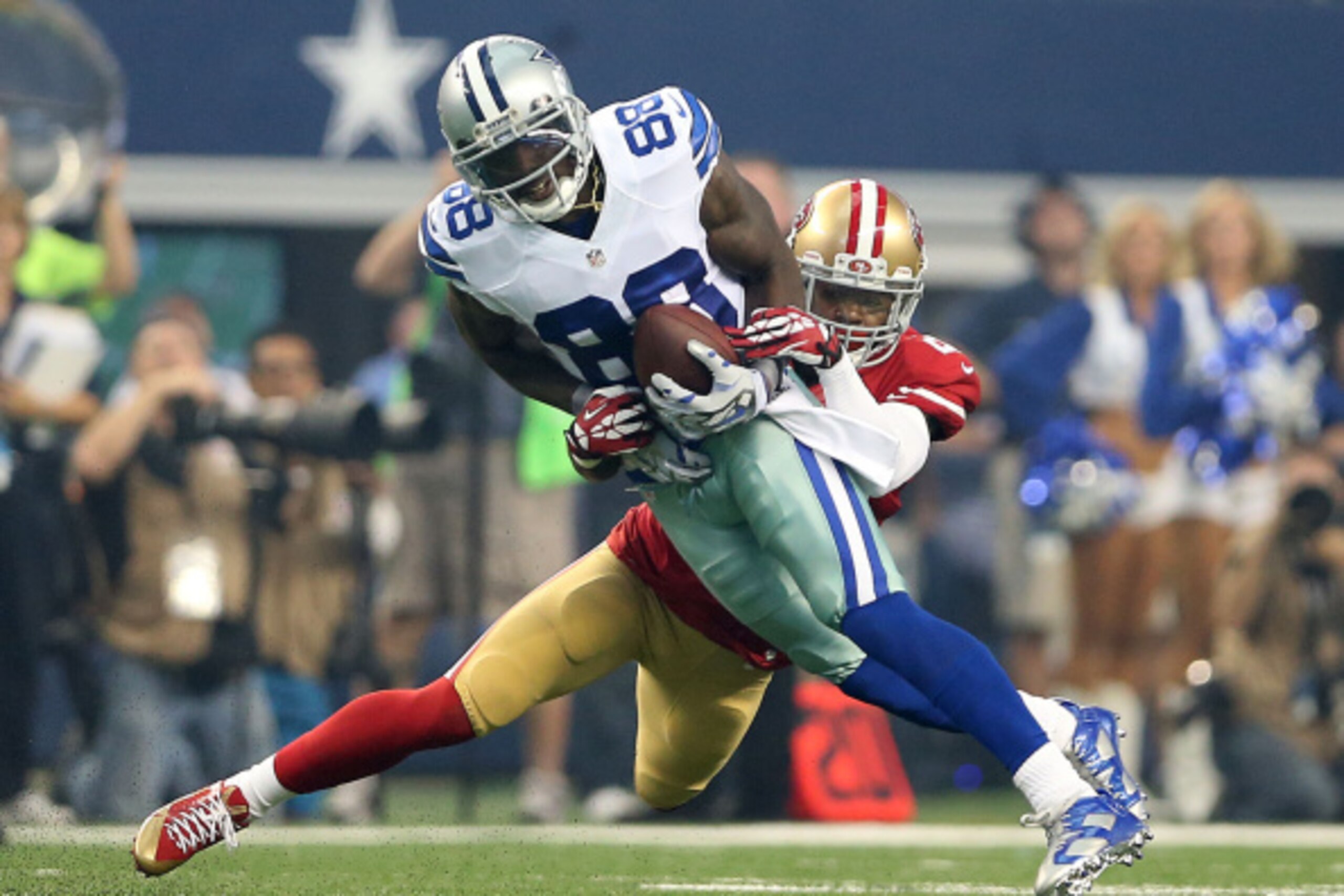 ARLINGTON, TX - SEPTEMBER 07:  Dez Bryant #88 of the Dallas Cowboys is tackled by Tramaine Brock #26 of the San Francisco 49ers in the first half at AT&T Stadium on September 7, 2014 in Arlington, Texas.  (Photo by Christian Petersen/Getty Images)