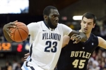 Feb 26, 2014; Villanova, PA, USA; Villanova Wildcats forward Daniel Ochefu (23) is defended by Butler Bulldogs forward Andrew Chrabascz (45) during the first half at The Pavilion. Mandatory Credit: Howard Smith-USA TODAY Sports