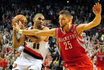 PORTLAND, OR - APRIL  27: Nicolas Batum #88 of the Portland Trail Blazers drives to the basket on Chandler Parsons #25 of the Houston Rockets in the second half of Game Four of the Western Conference Quarterfinals during the 2014 NBA Playoffs at the Moda 