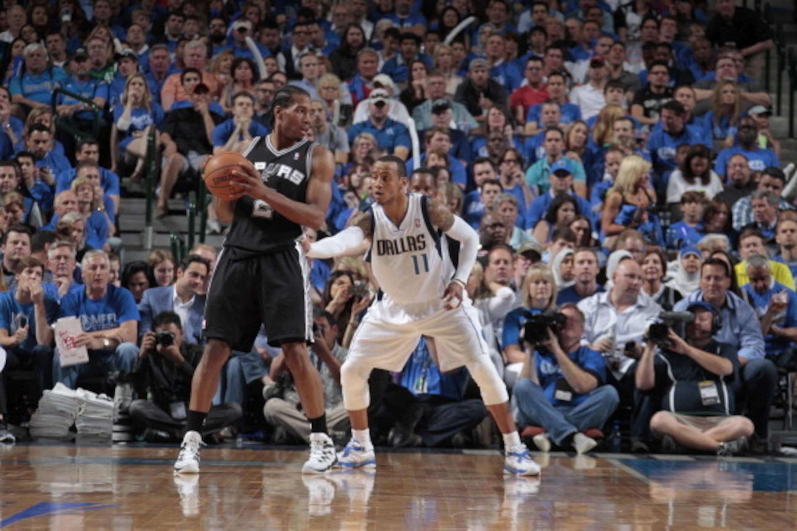 DALLAS, TX - MAY 2: Kawhi Leonard #2 of the San Antonio Spurs posts up against Monta Ellis #11 of the Dallas Mavericks during Game Six of the Western Conference Quarterfinals during the 2014 NBA Playoffs on May 2, 2014 at the American Airlines Center in D