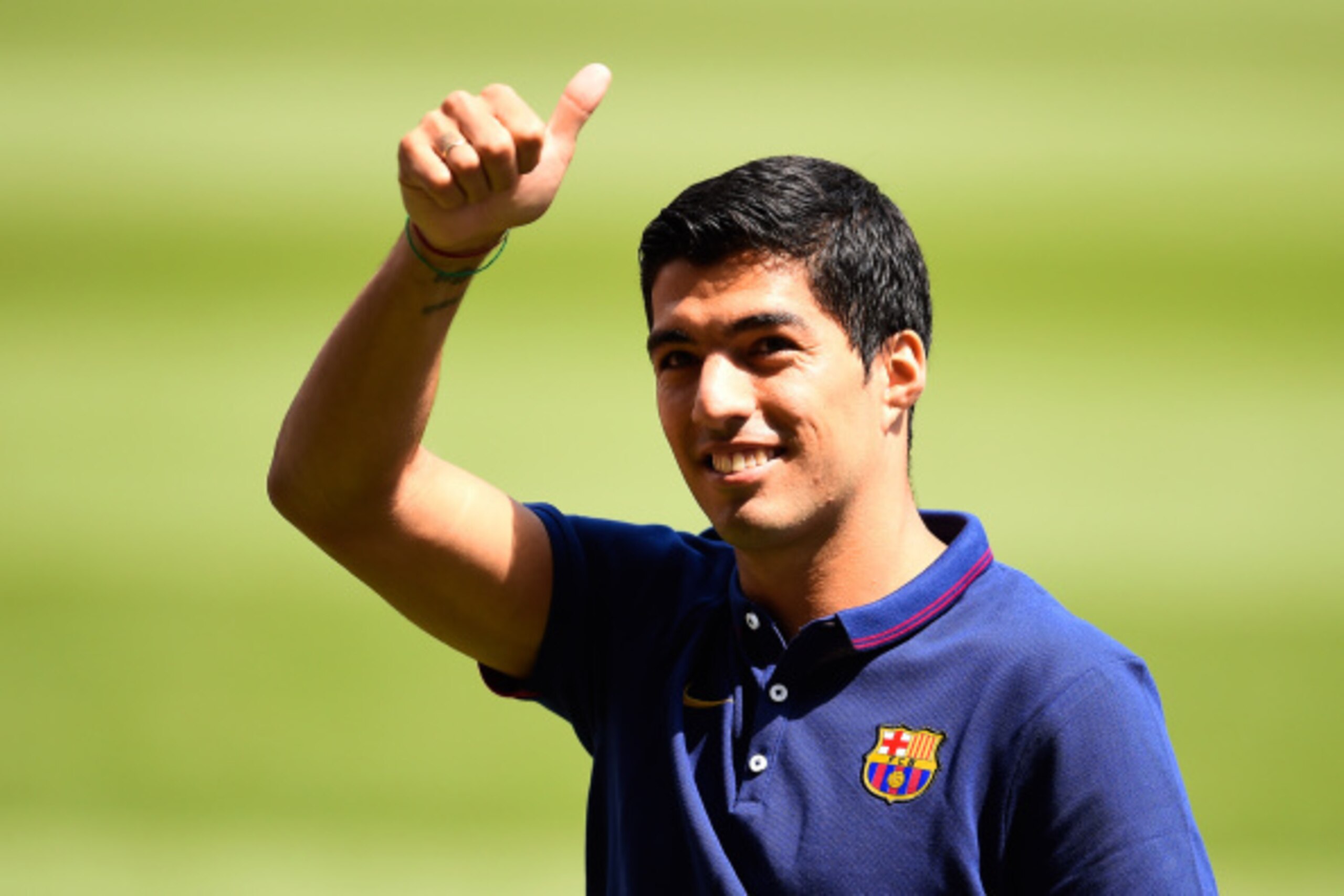 BARCELONA, SPAIN - AUGUST 19:  Luis Suarez of FC Barcelona gives his thumbs up during his presentation as new FC Barcelona player at Camp Nou on August 19, 2014 in Barcelona, Spain.  (Photo by David Ramos/Getty Images)