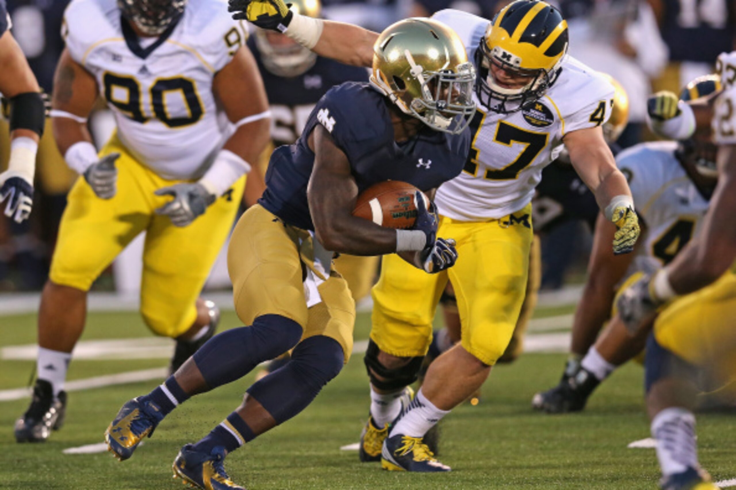 SOUTH BEND, IN - SEPTEMBER 06: Greg Bryant #1 of the Notre Dame Fighting Irish runs as Jake Ryan #47 of the Michigan Wolverines closes in at Notre Dame Stadium on September 6, 2014 in South Bend, Indiana. (Photo by Jonathan Daniel/Getty Images)