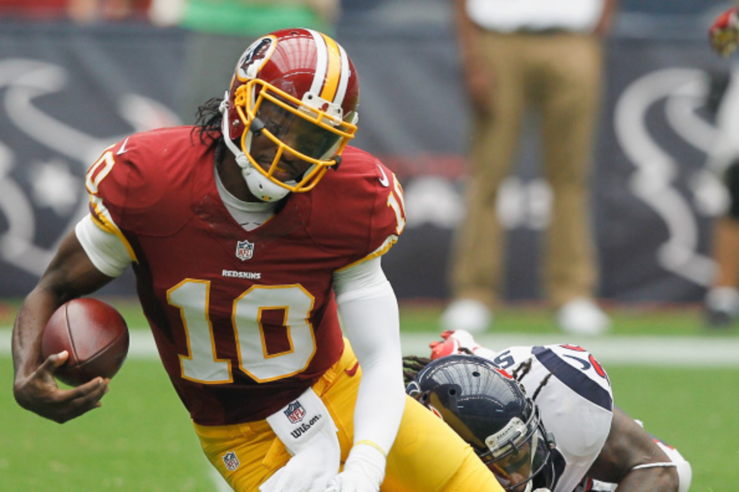 HOUSTON, TX - SEPTEMBER 07:  Robert Griffin III #10 of the Washington Redskins is sacked by D.J. Swearinger #36 of the Houston Texans at Reliant Stadium on September 7, 2014 in Houston, Texas.  (Photo by Bob Levey/Getty Images)