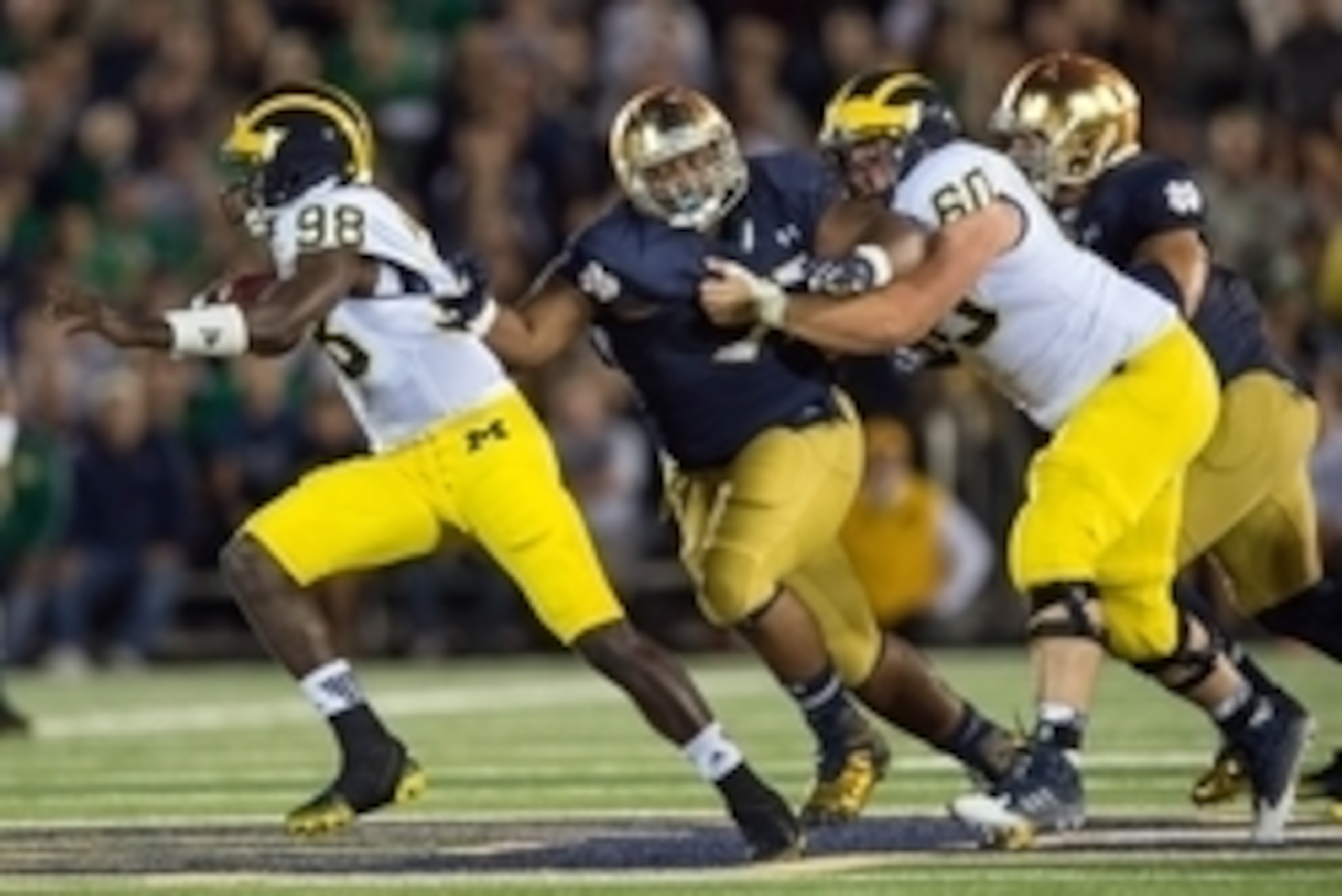 Sep 6, 2014; South Bend, IN, USA; Michigan Wolverines quarterback Devin Gardner (98) attempts to escape pressure from Notre Dame Fighting Irish defensive lineman Daniel Cage (75) in the fourth quarter at Notre Dame Stadium. Notre Dame won 31-0. Mandatory