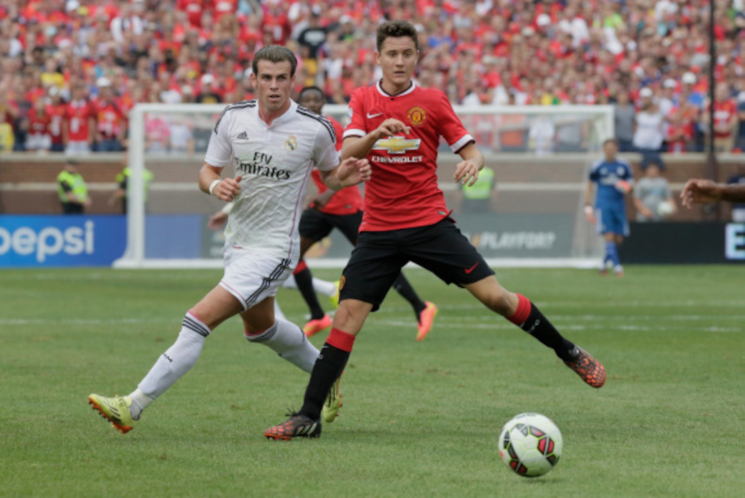 ANN ARBOR, MI - AUGUST 2: Ander Herrera #21 of Manchester United keeps the ball away from Gareth Bale #11 of Real Madrid during the first half of the Guinness International Champions Cup at Michigan Stadium on August 2, 2014, in Ann Arbor, Mich (Photo by 