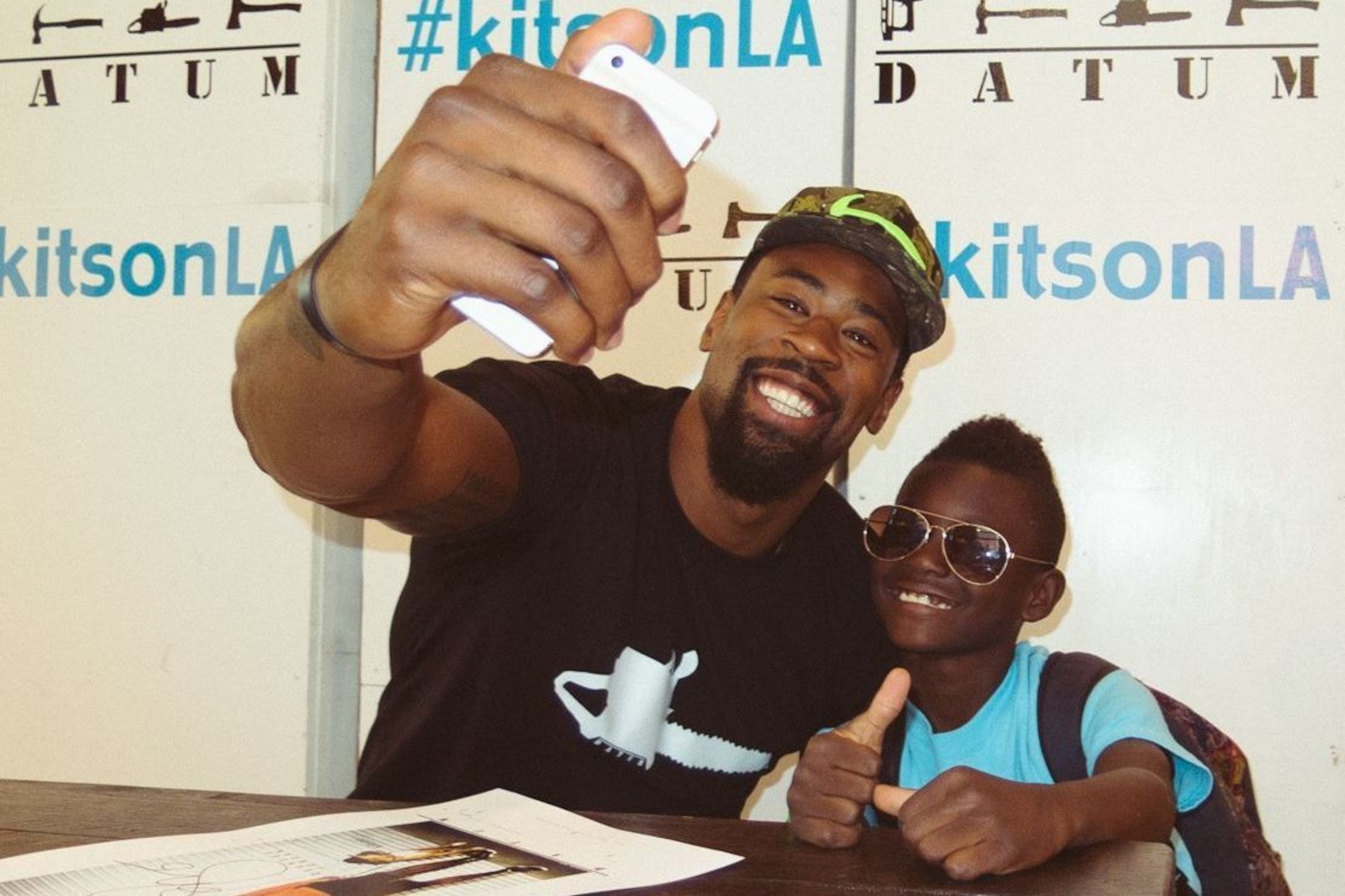 DeAndre Jordan with a young fan at the Datum clothing line launch event.