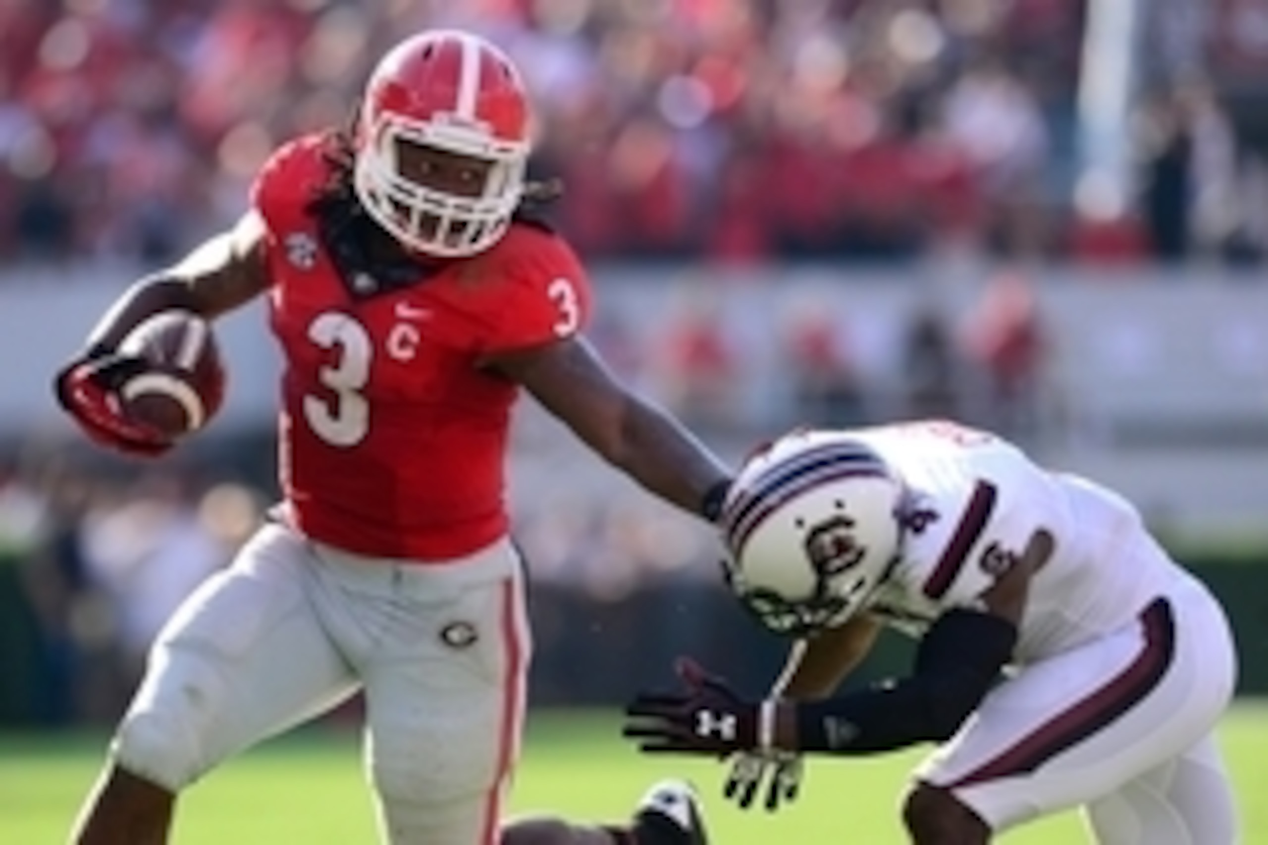 Sep 7, 2013; Athens, GA, USA; Georgia Bulldogs running back Todd Gurley (3) straight arms South Carolina Gamecocks cornerback Ahmad Christian (4) during the second quarter at Sanford Stadium. Mandatory Credit: Dale Zanine-USA TODAY Sports