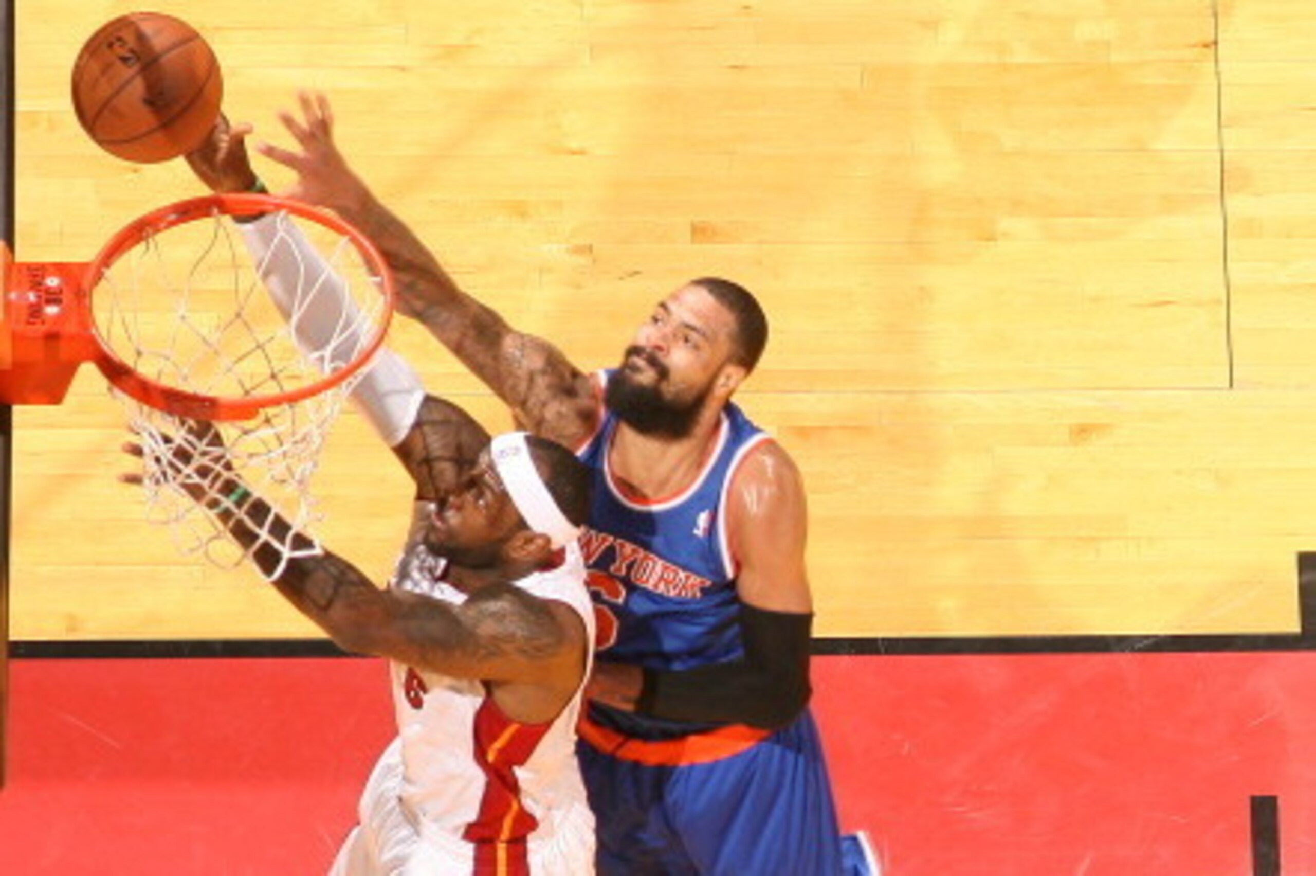 MIAMI, FL - APRIL 6: LeBron James #6 of the Miami Heat shoots against Tyson Chandler #6 of the New York Knicks during a game on April 6, 2014 at American Airlines Arena in Miami, Florida.  NOTE TO USER: User expressly acknowledges and agrees that, by down