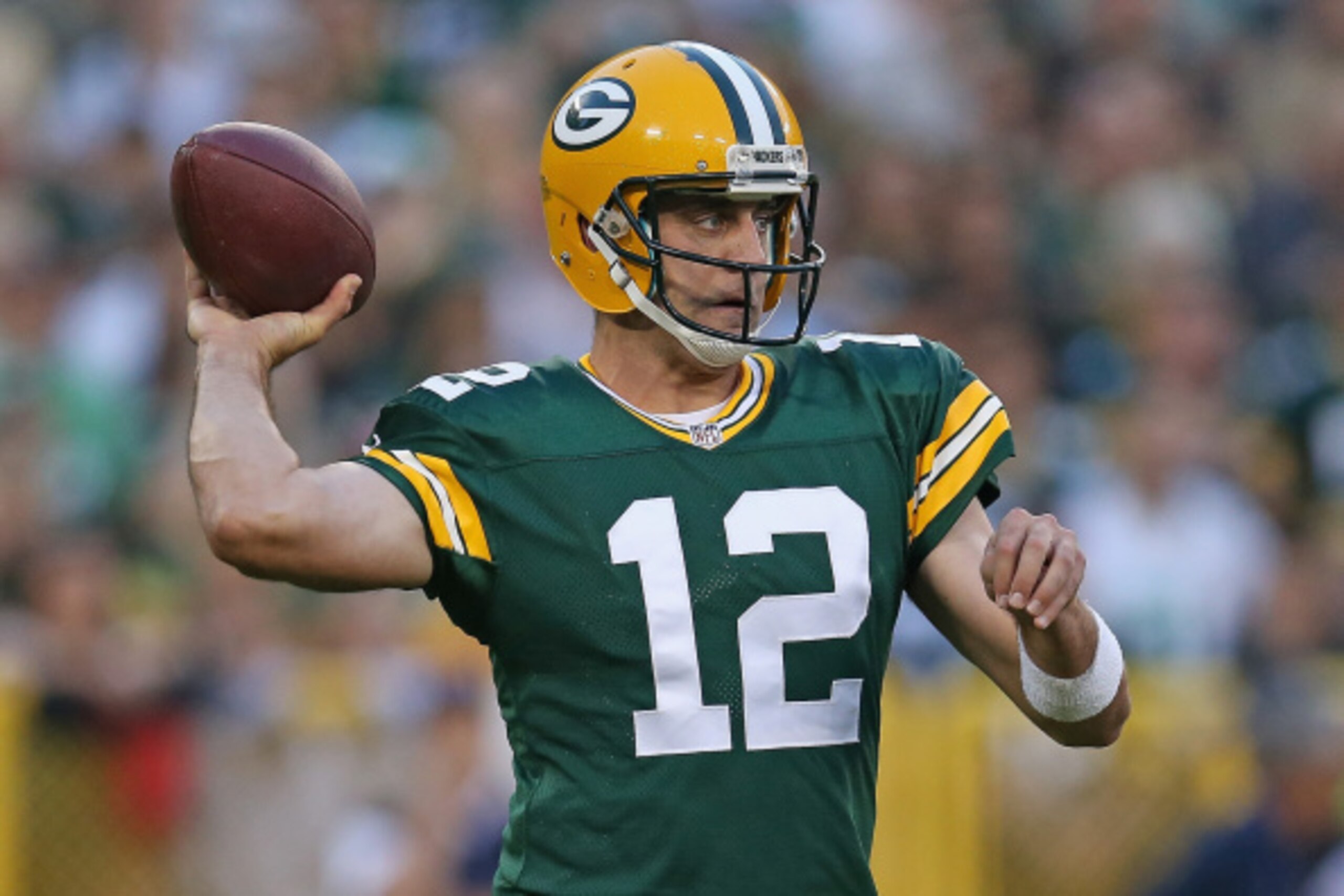 GREEN BAY, WI - AUGUST 22:  Quarterback Aaron Rodgers #12 of the Green Bay Packers looks to pass during the first quarter of a preseason game against the Oakland Raiders at Lambeau Field on August 22, 2014 in Green Bay, Wisconsin. The Packers defeated the