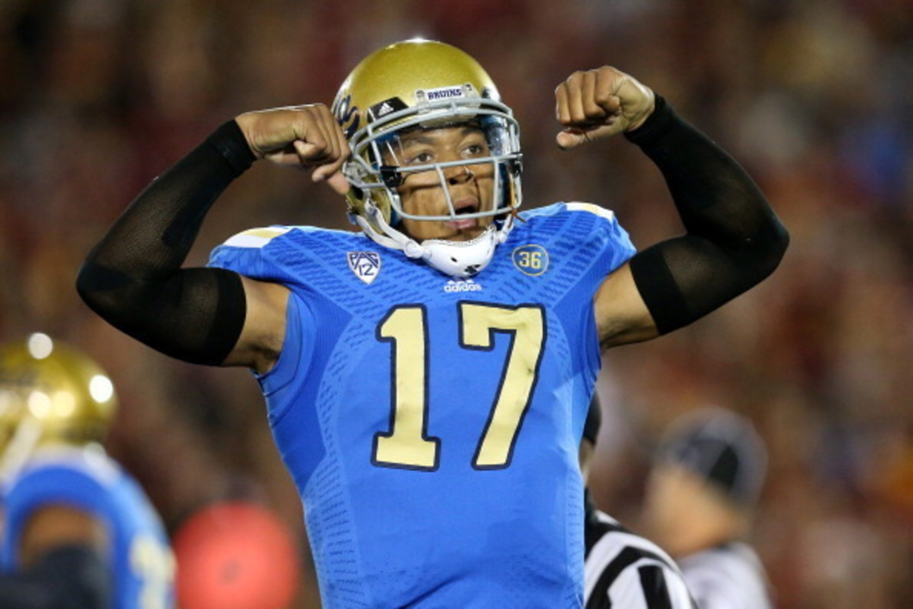 LOS ANGELES, CA - NOVEMBER 30: Quarterback Brett Hundley #17 of the UCLA Bruins flexes as he celebrates a Myles Jack three yard touchdown run in the first quarter against the USC Trojans at Los Angeles Coliseum on November 30, 2013 in Los Angeles, Califo LOS ANGELES, CA - NOVEMBER 30: Quarterback Brett Hundley #17 of the UCLA Bruins flexes as he celebrates a Myles Jack three yard touchdown run in the first quarter against the USC Trojans at Los Angeles Coliseum on November 30, 2013 in Los Angeles, Califo