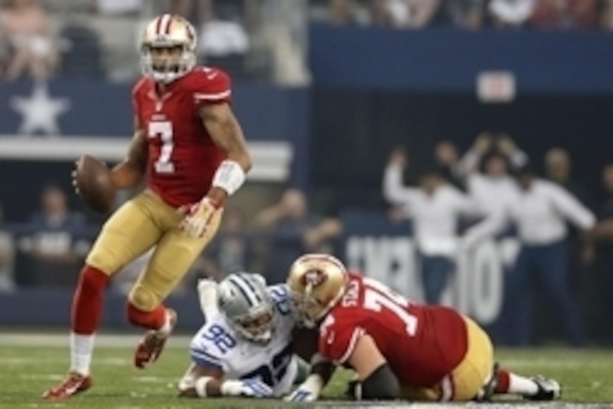 Sep 7, 2014; Arlington, TX, USA; San Francisco 49ers quarterback Colin Kaepernick scrambles against the Dallas Cowboys at AT&T Stadium. Mandatory Credit: Matthew Emmons-USA TODAY Sports