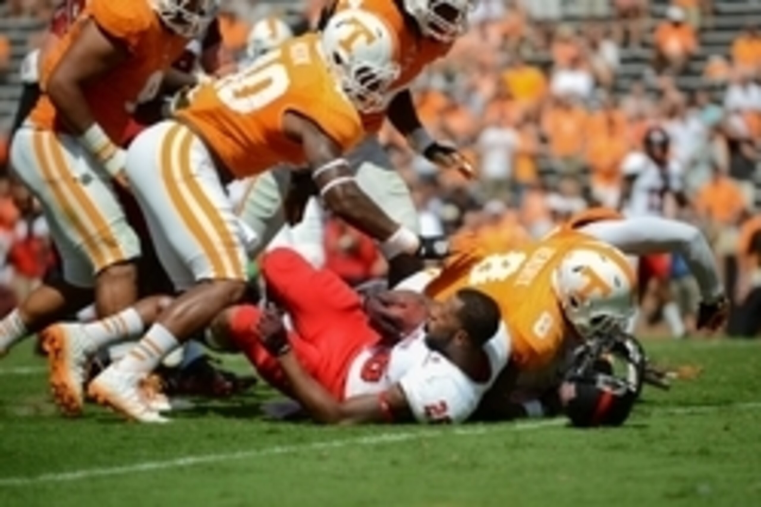 Sep 6, 2014; Knoxville, TN, USA; Arkansas State Red Wolves wide receiver DeKeathan Williams (26) is tackled by Tennessee Volunteers defensive lineman Dewayne Hendrix (8)  during the second half at Neyland Stadium. Tennessee won 34 to 19. Mandatory Credit: