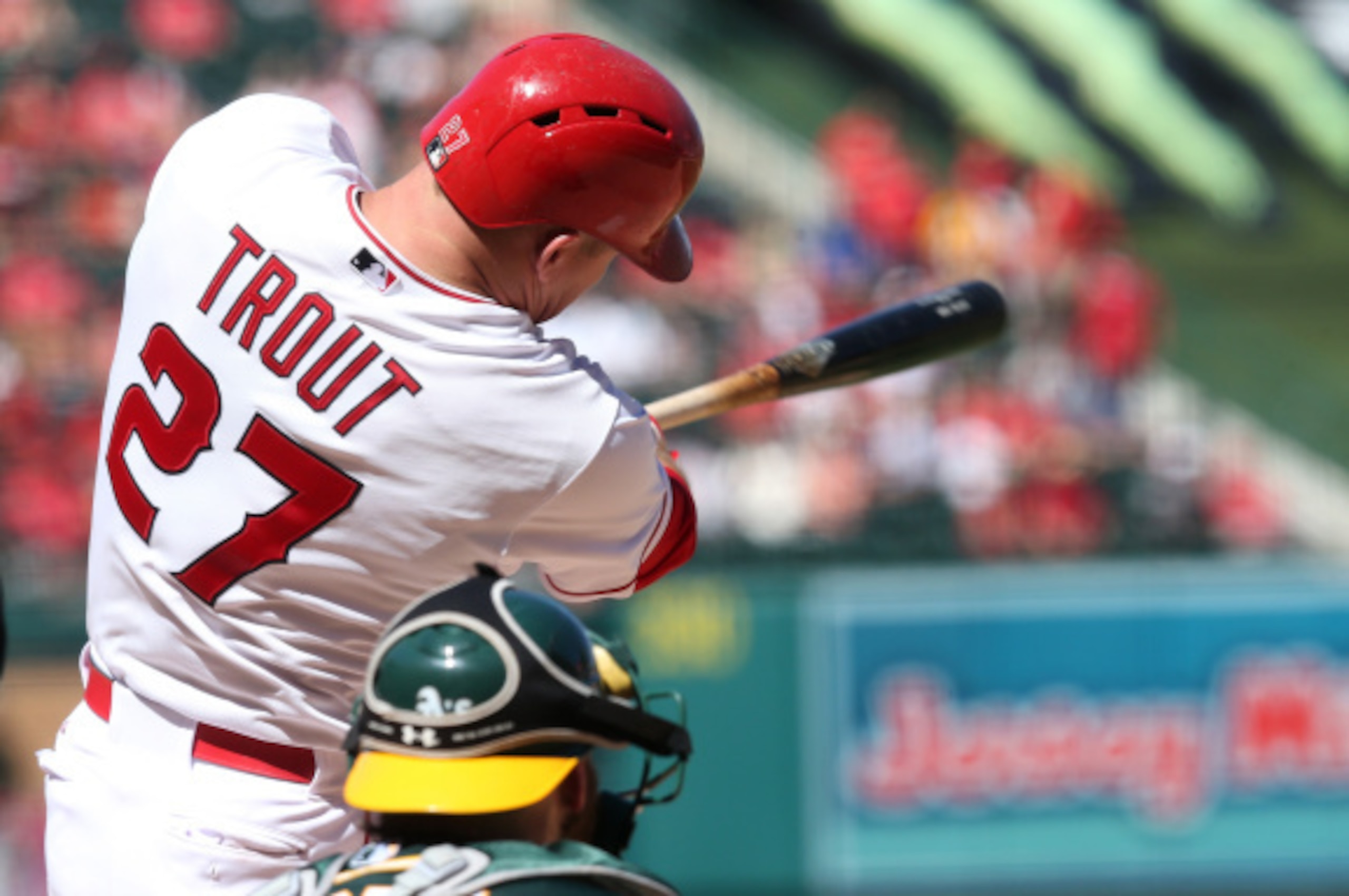 ANAHEIM, CA - AUGUST 31:  Mike Trout #27 of the Los Angeles Angels of Anaheim hits a solo home in the seventh inning against the Oakland Athletics at Angel Stadium of Anaheim on August 31, 2014 in Anaheim, California. The Angels won 8-1 to complete a four