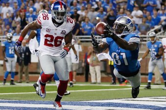 DETROIT, MI - SEPTEMBER 08: Calvin Johnson #81 of the Detroit Lions catches a first quarter touchdown next to Antrel Rolle #26 of the New York Giants at Ford Field on September 8, 2014 in Detroit, Michigan. (Photo by Gregory Shamus/Getty Images)