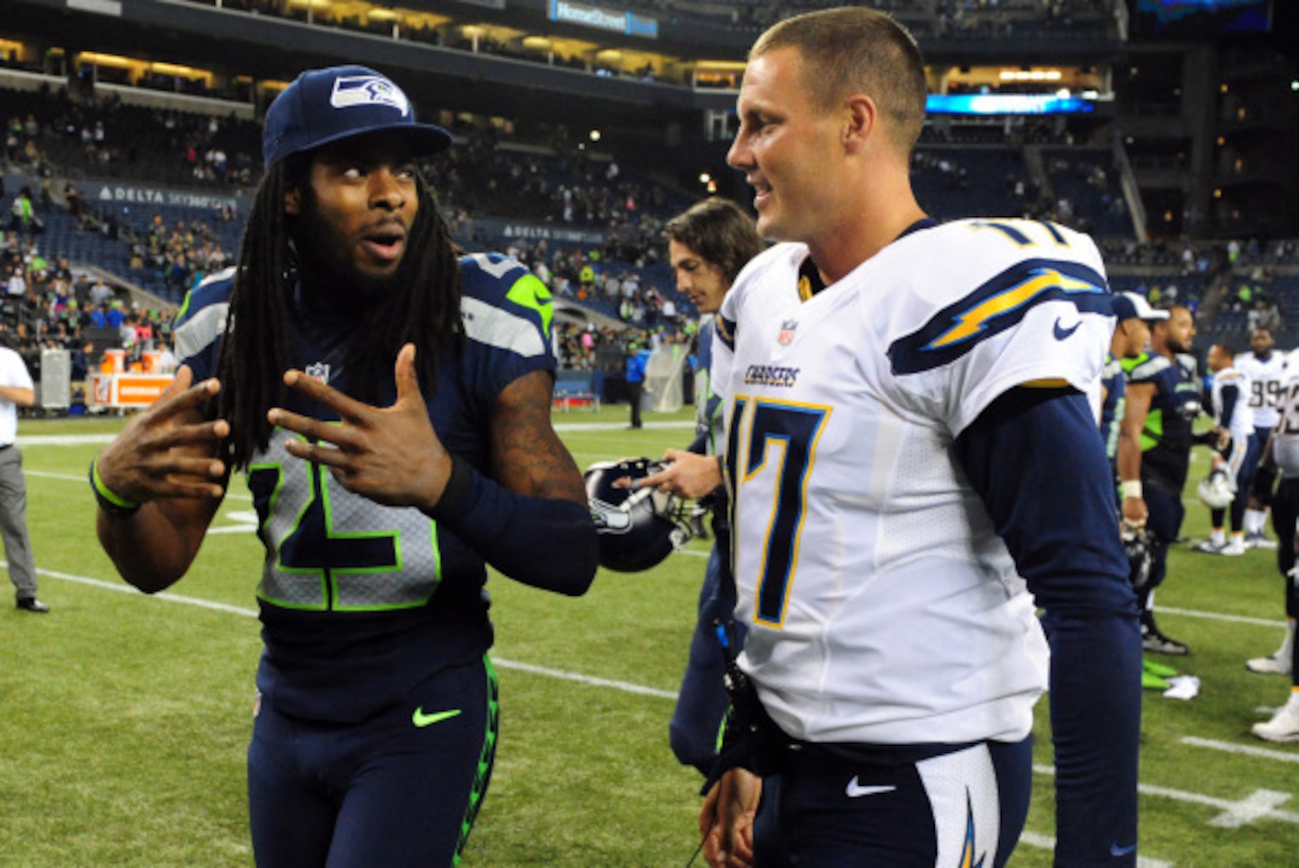 SEATTLE, WA - AUGUST 15: Cornerback Richard Sherman #25 of the Seattle Seahawks and quarterback Philip Rivers #17 of the San Diego Chargers speak after the game at CenturyLink Field on August 15, 2014 in Seattle, Washington. (Photo by Steve Dykes/Getty Im