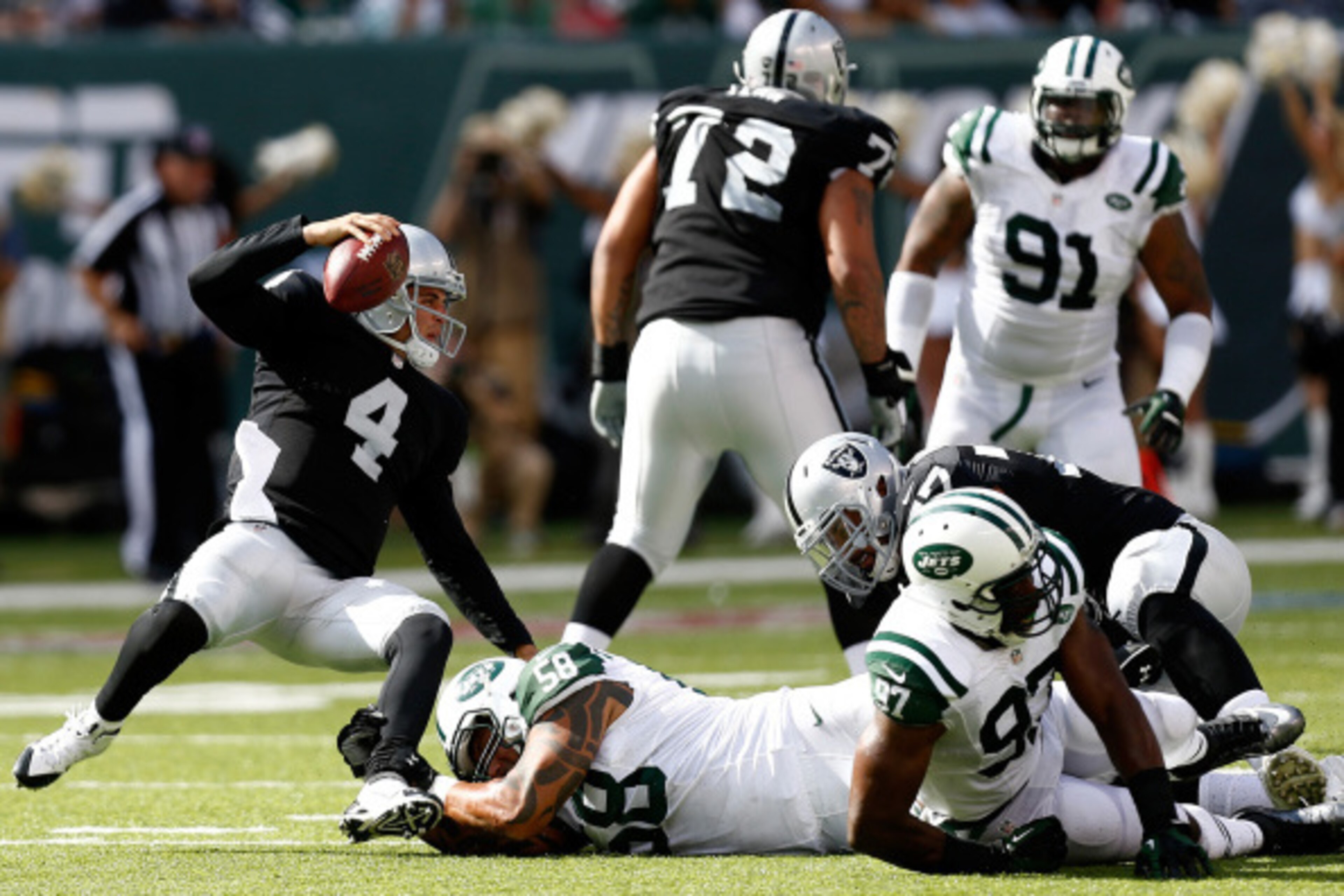 EAST RUTHERFORD, NJ - SEPTEMBER 07: Jason Babin #58 of the New York Jets sacks Derek Carr #4 of the Oakland Raiders during the fourth quarter at MetLife Stadium on September 7, 2014 in East Rutherford, New Jersey. (Photo by Jeff Zelevansky/Getty Image EAST RUTHERFORD, NJ - SEPTEMBER 07: Jason Babin #58 of the New York Jets sacks Derek Carr #4 of the Oakland Raiders during the fourth quarter at MetLife Stadium on September 7, 2014 in East Rutherford, New Jersey. (Photo by Jeff Zelevansky/Getty Image