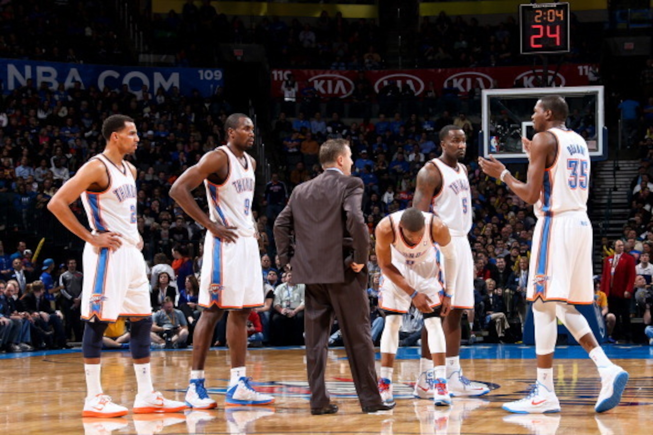 OKLAHOMA CITY, OK - JANUARY 2: Kevin Durant #35 of the Oklahoma City Thunder speaks to head coach Scott Brooks and teammates Thabo Sefolosha #2, Serge Ibaka #9, Russell Westbrook #0 and Kendrick Perkins #5 during a game against the Brooklyn Nets on Januar
