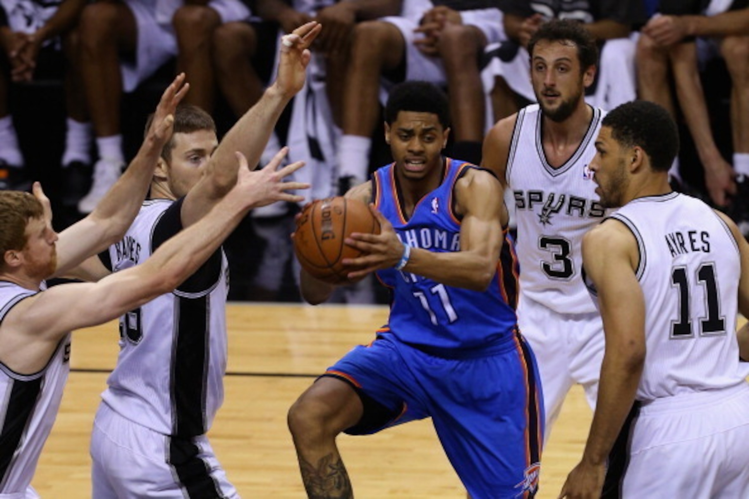 SAN ANTONIO, TX - MAY 29: Jeremy Lamb #11 of the Oklahoma City Thunder looks to pass against Matt Bonner #15, Aron Baynes #16, Marco Belinelli #3 and Jeff Ayres #11 of the San Antonio Spurs in the fourth quarter during Game Five of the Western Conference 