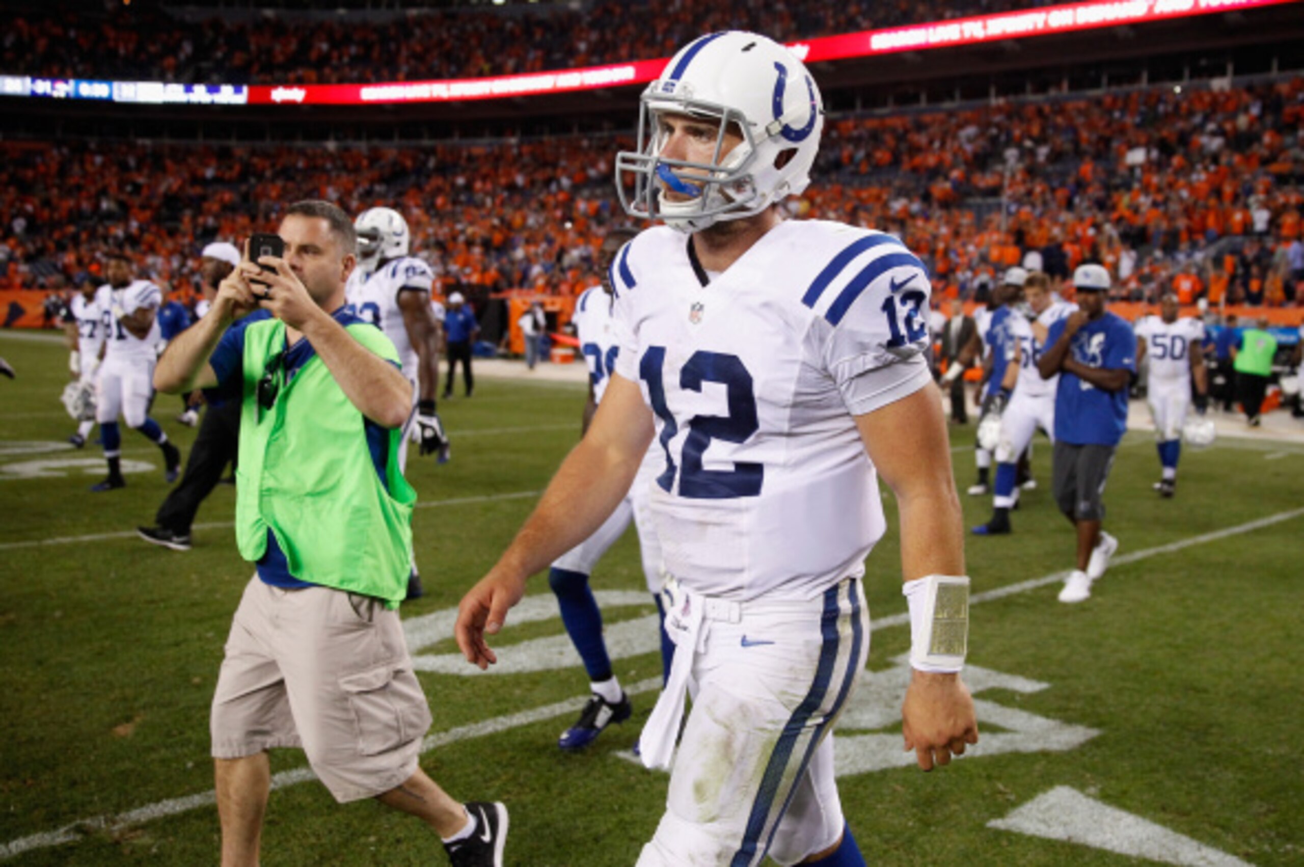 DENVER, CO - SEPTEMBER 07:  Quarterback Andrew Luck #12 of the Indianapolis Colts walks off the field after being defeated by the Denver Broncos 31-24 at Sports Authority Field at Mile High on September 7, 2014 in Denver, Colorado.  (Photo by Doug Pensing