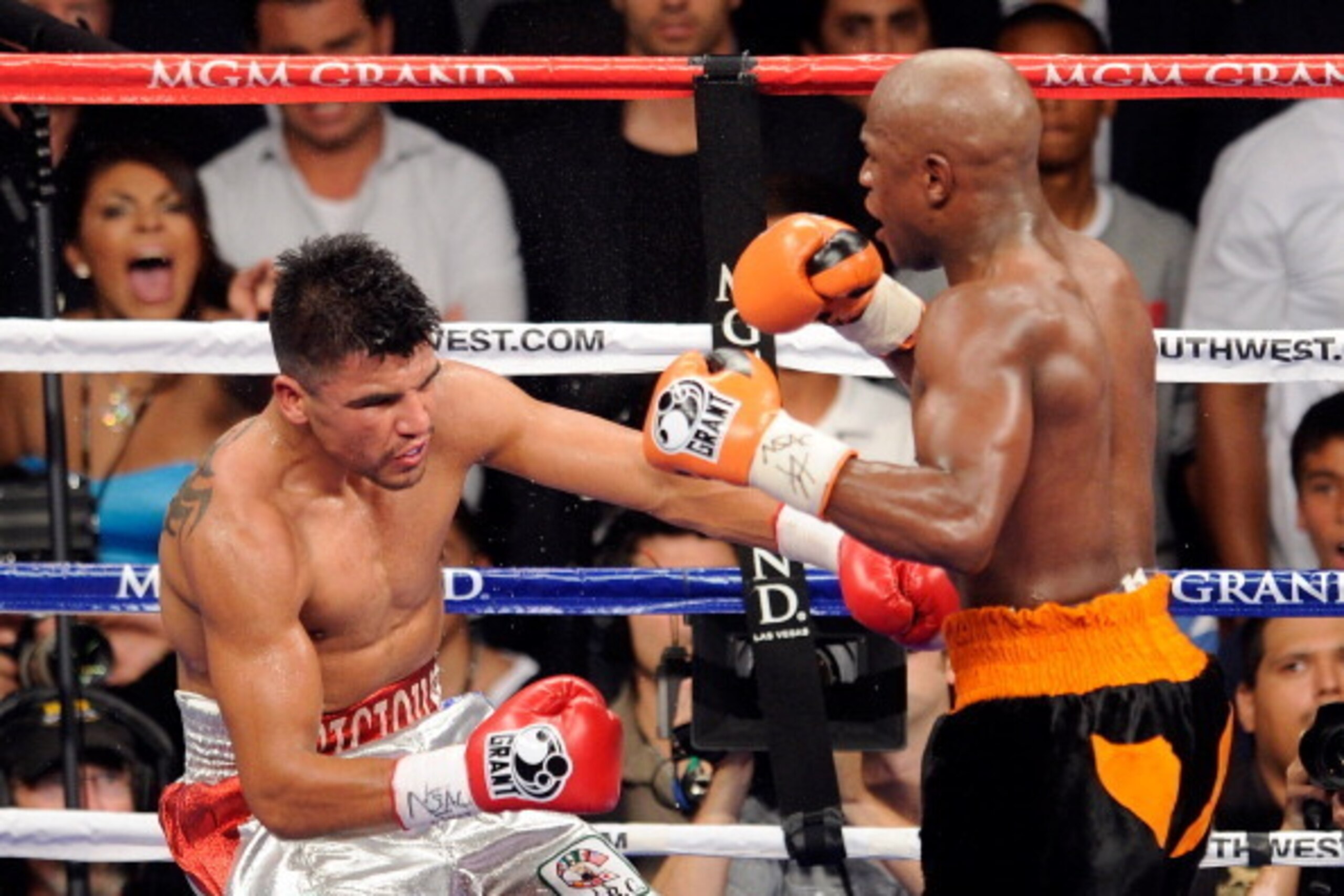 LAS VEGAS, NV - SEPTEMBER 17:  (R-L) Floyd Mayweather Jr. knocks out Victor Ortiz in the fourth round during their WBC welterweight title fight at the MGM Grand Garden Arena on September 17, 2011 in Las Vegas, Nevada.  (Photo by Ethan Miller/Getty Images)