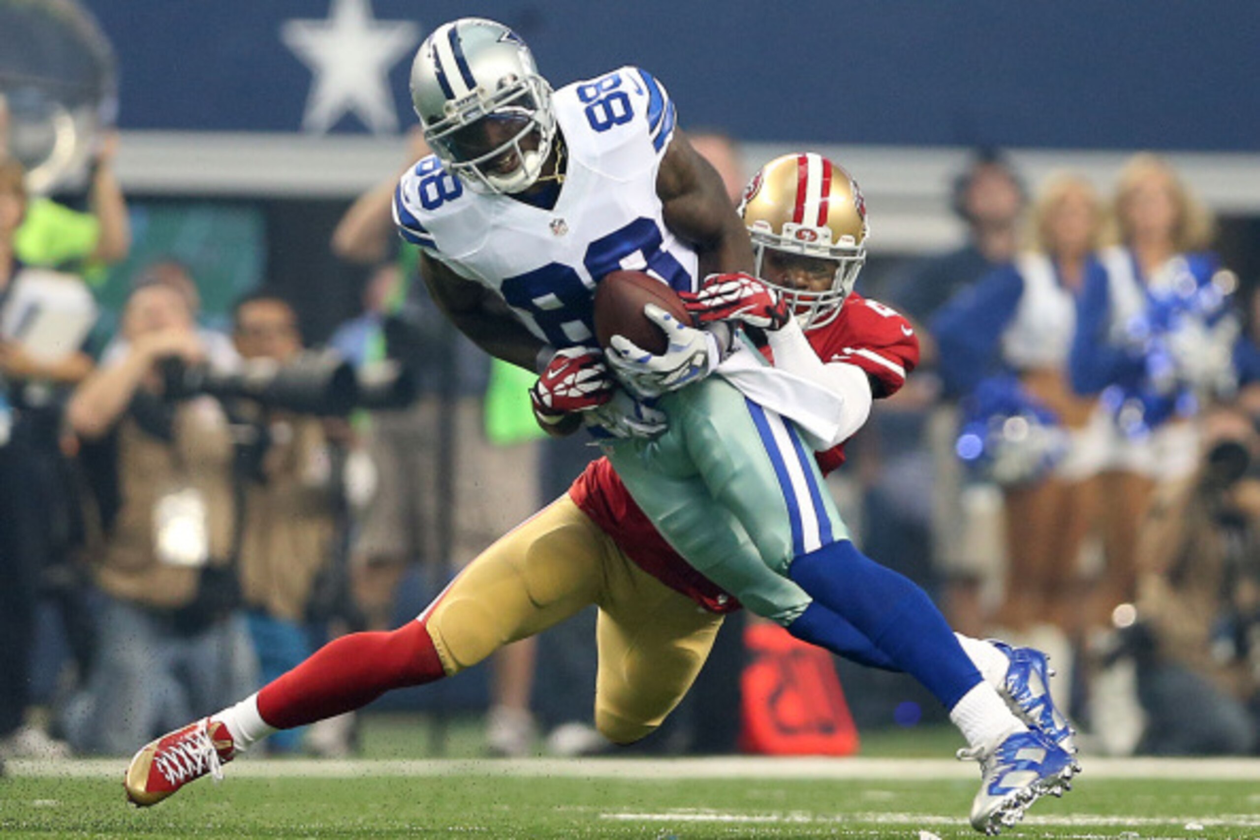 ARLINGTON, TX - SEPTEMBER 07:  Dez Bryant #88 of the Dallas Cowboys is tackled by Tramaine Brock #26 of the San Francisco 49ers in the first half at AT&T Stadium on September 7, 2014 in Arlington, Texas.  (Photo by Christian Petersen/Getty Images)