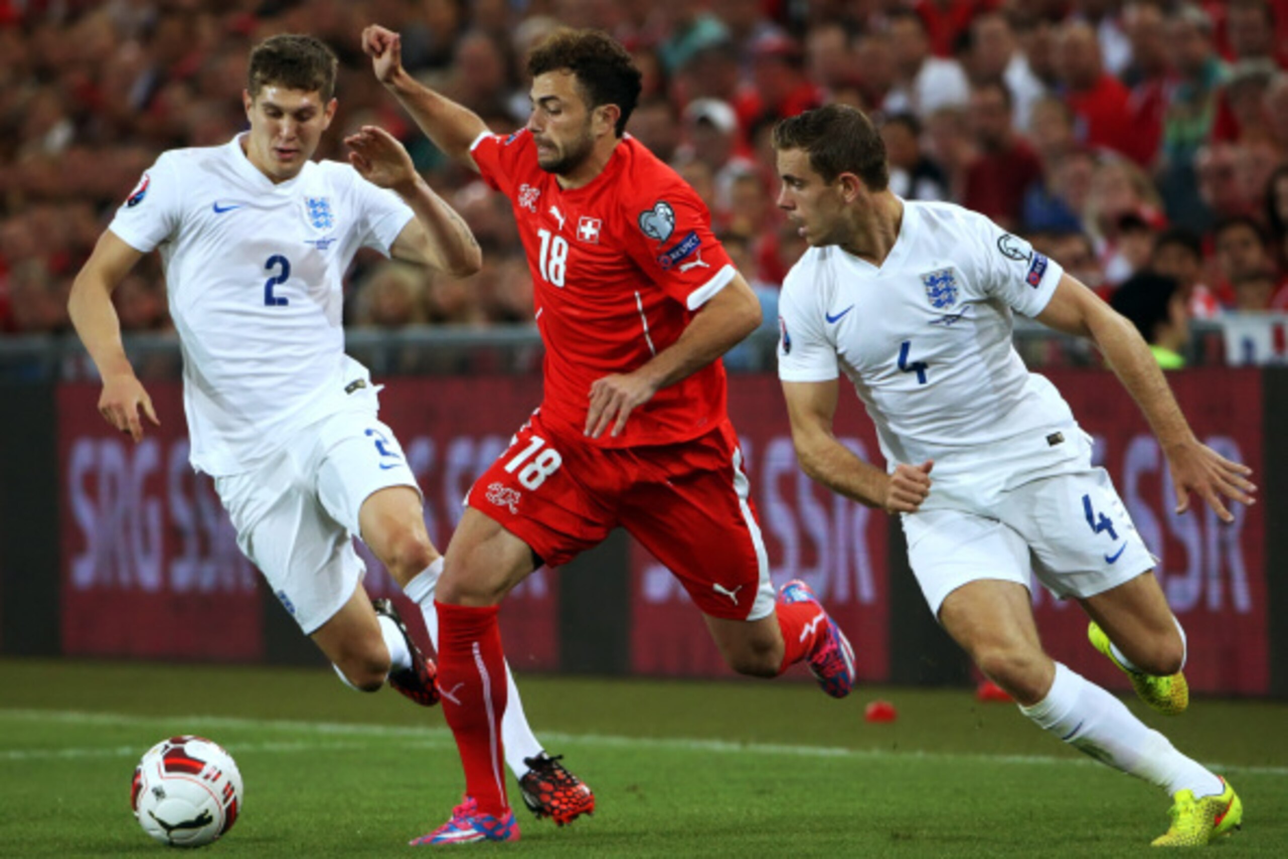 BASEL, SWITZERLAND - SEPTEMBER 08: Admir Mehmedi of Switzerland (C) fights for the ball with John Stones (L) and Jordan Henderson of England during the EURO 2016 Qualifier match between Switzerland and England on September 8, 2014 in Basel, Switzerland. ( BASEL, SWITZERLAND - SEPTEMBER 08: Admir Mehmedi of Switzerland (C) fights for the ball with John Stones (L) and Jordan Henderson of England during the EURO 2016 Qualifier match between Switzerland and England on September 8, 2014 in Basel, Switzerland. (