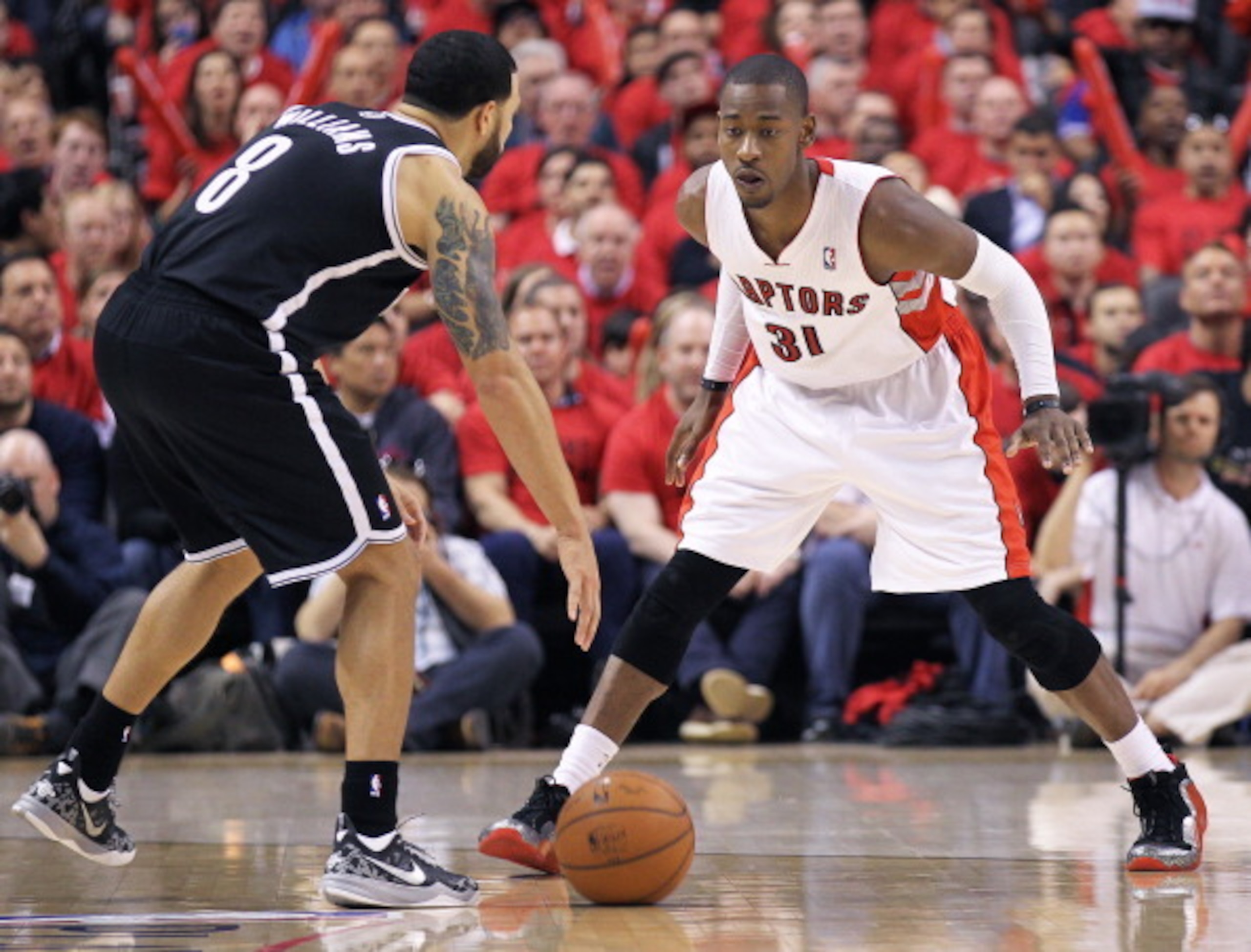 TORONTO, ON - MAY 4:  Terrence Ross #31 of the Toronto Raptors defends against Deron Williams #8 of the Brooklyn Nets in Game Seven of the NBA Eastern Conference Quarterfinals at the Air Canada Centre on May 4, 2014 in Toronto, Ontario, Canada. The Nets d