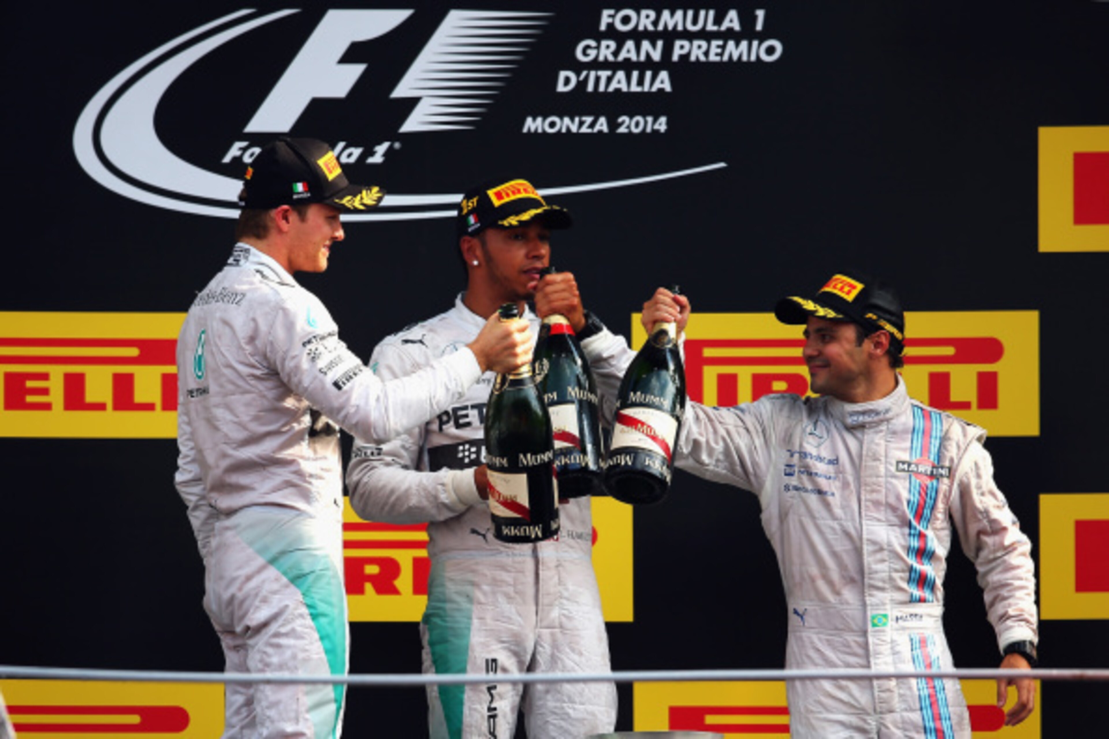 MONZA, ITALY - SEPTEMBER 07:  Lewis Hamilton (C) of Great Britain and Mercedes GP celebrates his victory with second placed Nico Rosberg (L) of Germany and Mercedes GP and third placed Felipe Massa (R) of Brazil and Williams following the F1 Grand Prix of