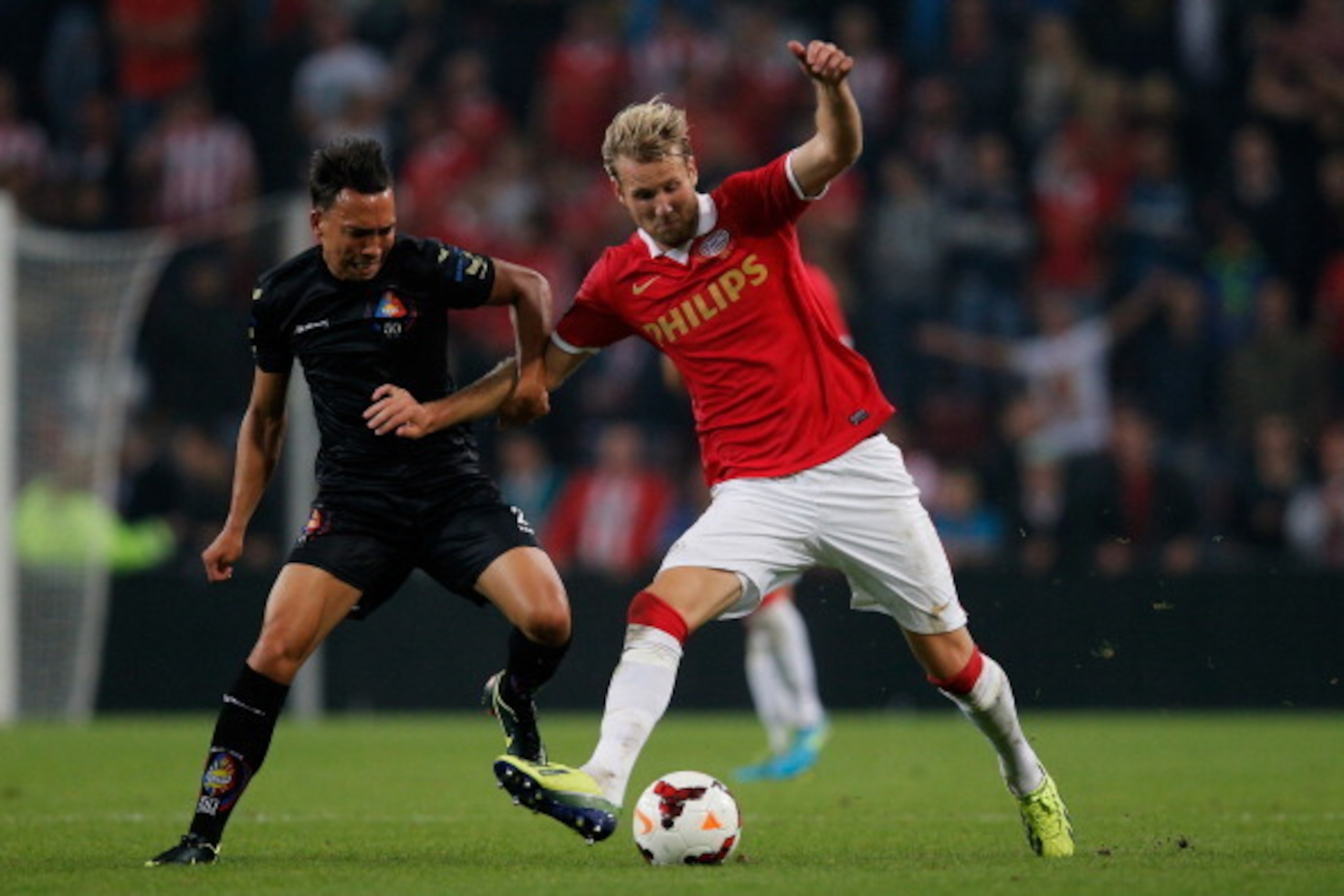 EINDHOVEN, NETHERLANDS - SEPTEMBER 25:  Ola Toivonen of PSV and Gaston Salasiwa of Telstar battle for the ball during the Dutch Cup match between PSV Eindhoven and SC Stormvogels Telstar at the Philips Stadion on September 25, 2013 in Eindhoven, Netherlan