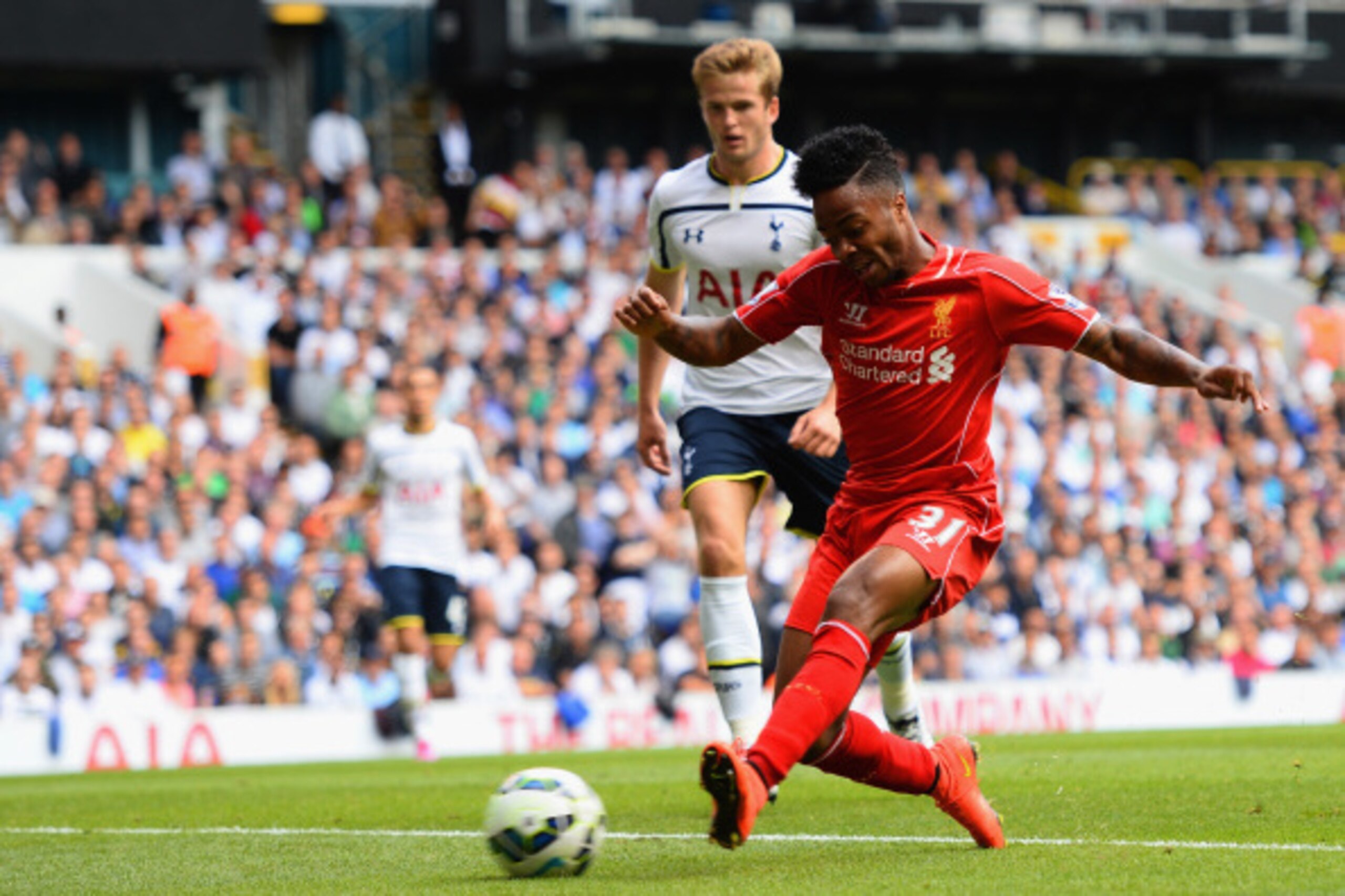 LONDON, ENGLAND - AUGUST 31:  Raheem Sterling of Liverpool scores the opening goal during the Barclays Premier League match between Tottenham Hotspur and Liverpool at White Hart Lane on August 31, 2014 in London, England.  (Photo by Jamie McDonald/Getty I