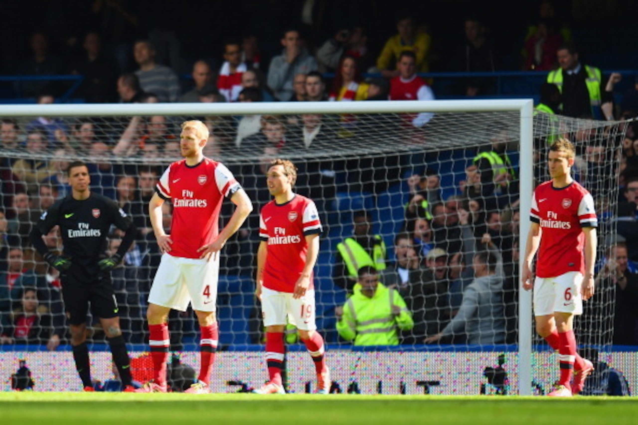 LONDON, ENGLAND - MARCH 22:  A dejected Per Mertesacker, Santi Cazorla and Laurent Koscielny of Arsenal after conceding the second goal during the Barclays Premier League match between Chelsea and Arsenal at Stamford Bridge on March 22, 2014 in London, En