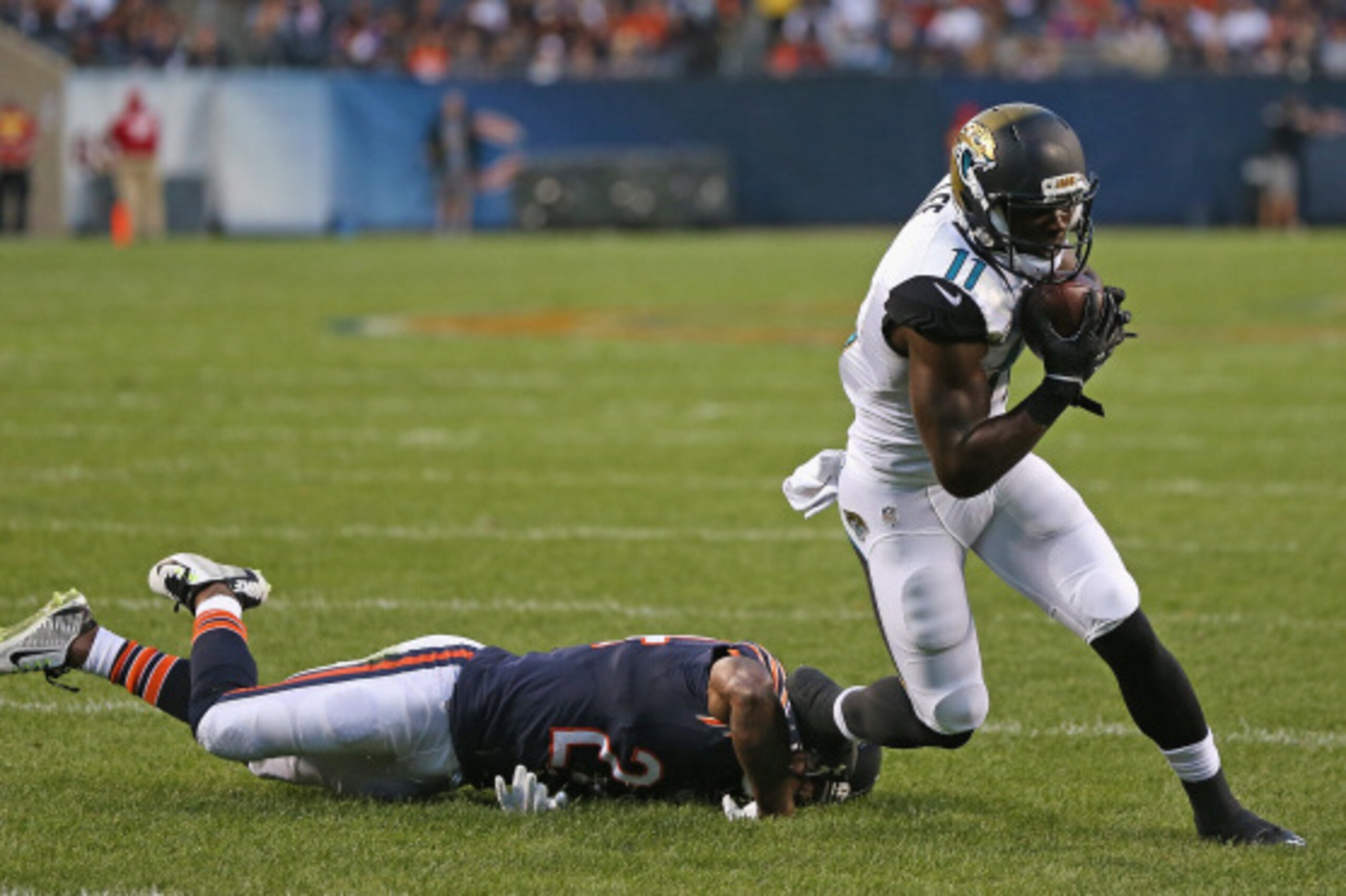 CHICAGO, IL - AUGUST 14:  Marqise Lee #11 of the Jacksonville Jaguars breaks away from Kelvin Hayden #24  of the Chicago Bears for a touchdown during the first quarter of a preseason game at Soldier Field on August 14, 2014 in Chicago, Illinois.  (Photo b