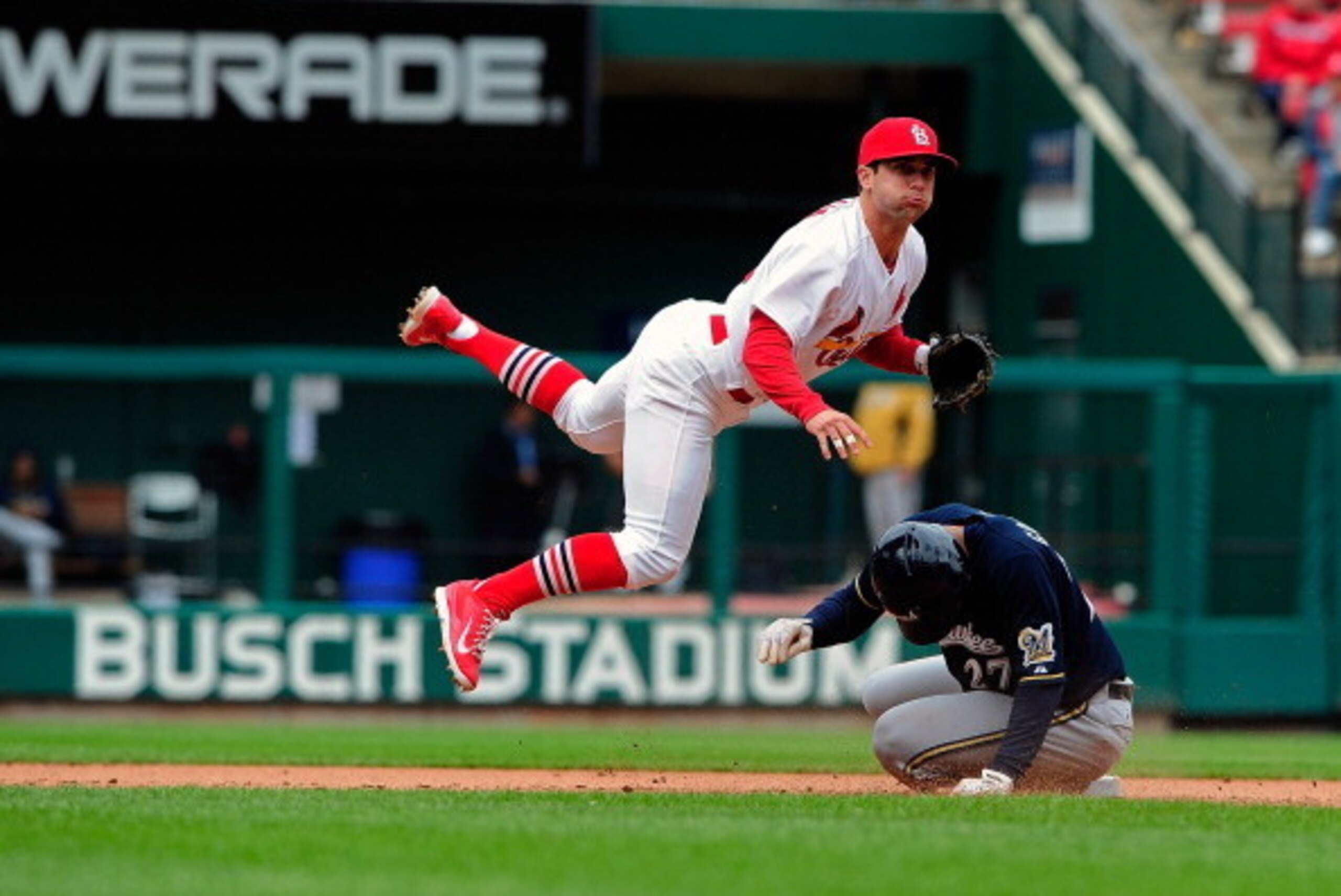 ST. LOUIS, MO - APRIL 30: Greg Garcia #12 of the St. Louis Cardinals leaps over Carlos Gomez #27 of the Milwaukee Brewers as he completes a double play during the seventh inning at Busch Stadium on April 30, 2014 in St. Louis, Missouri.  (Photo by Jeff Cu