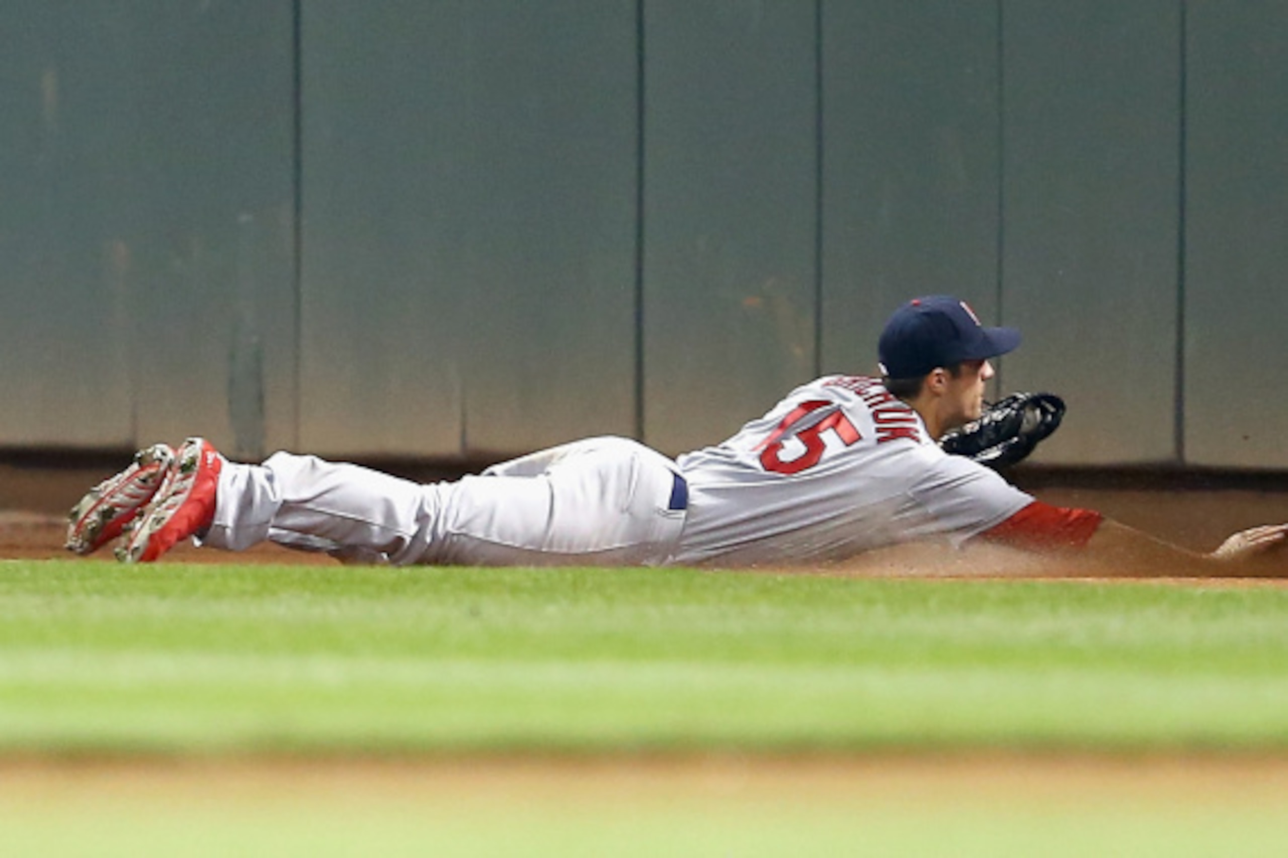 CINCINNATI, OH - SEPTEMBER 08:  Randal Grichuk #15 of the St. Louis Cardinals slides after catching the ball hit by Billy Hamilton of the Cincinnati Reds to end the game at Great American Ball Park on September 8, 2014 in Cincinnati, Ohio.  (Photo by Andy