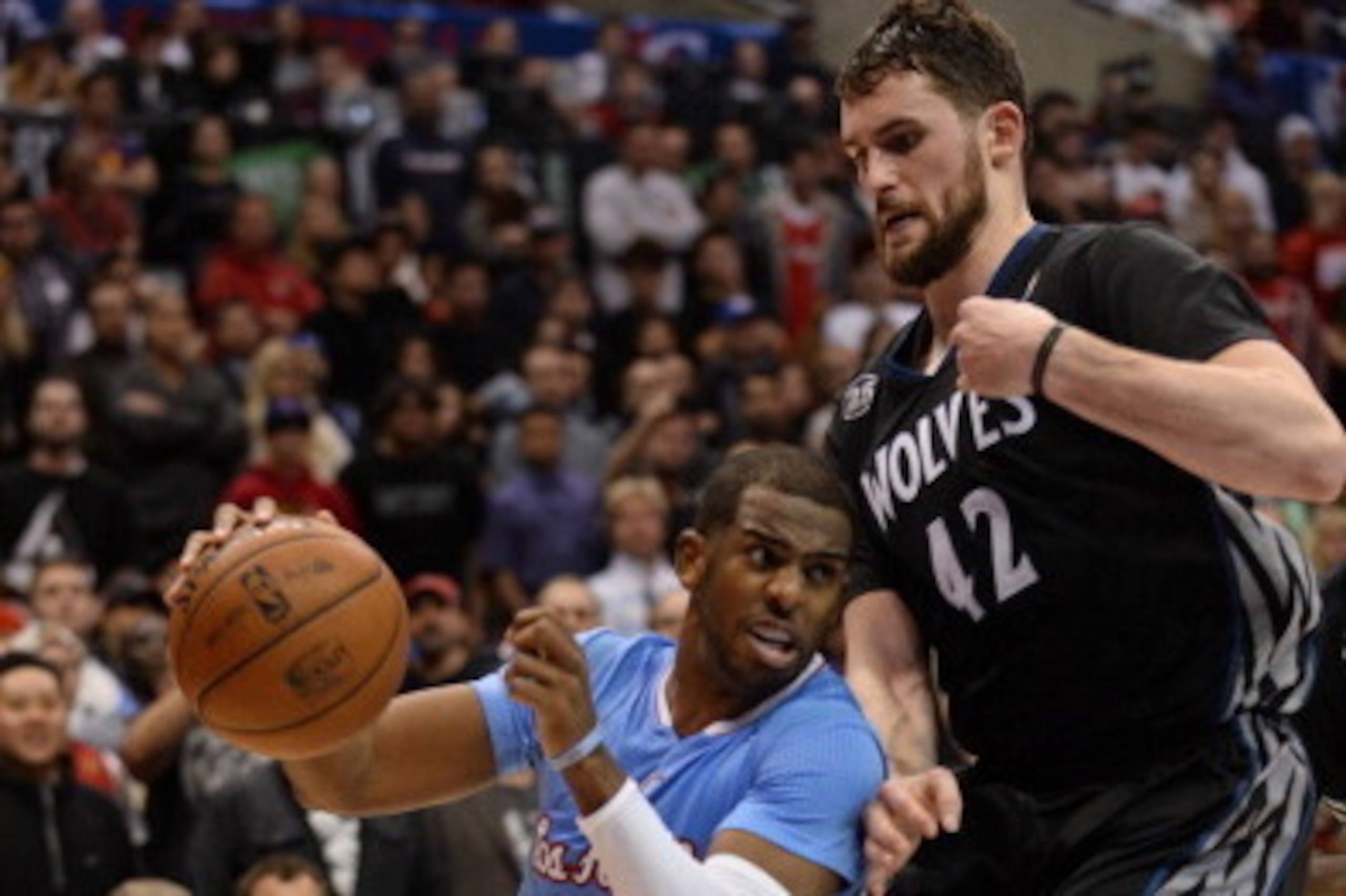 LOS ANGELES, CA - DECEMBER 22: Chris Paul #3 of the Los Angeles Clippers drives to the basket against Kevin Love #42 of the Minnesota Timberwolves at STAPLES Center on December 22, 2013 in Los Angeles, California. NOTE TO USER: User expressly acknowledges