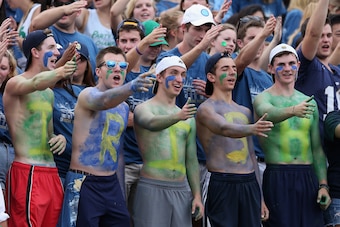 SOUTH BEND, IN - AUGUST 30: Student fans of the Notre Dame Fighting Irish cheer during a game against the Rice Owls at Notre Dame Stadium on August 30, 2014 in South Bend, Indiana. (Photo by Jonathan Daniel/Getty Images)