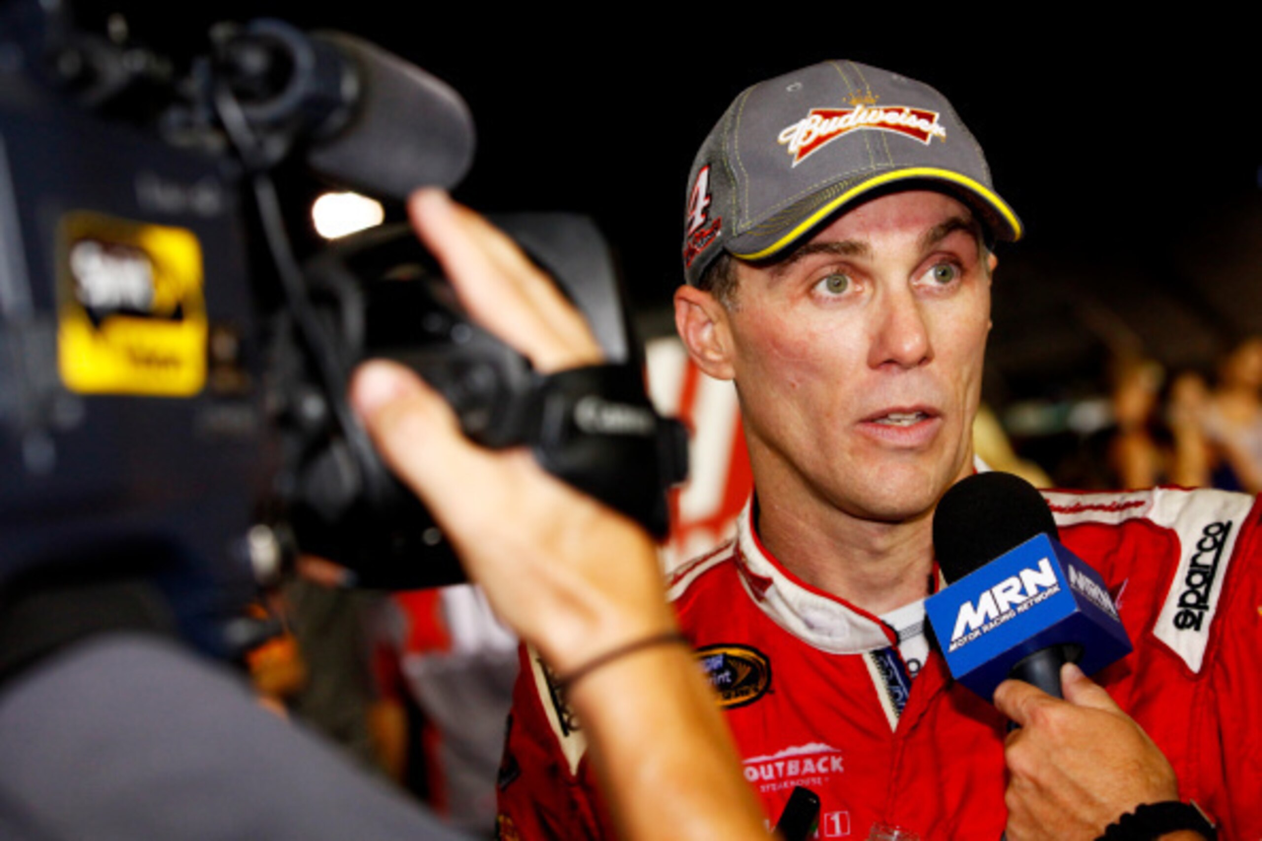 RICHMOND, VA - SEPTEMBER 06:  Kevin Harvick, driver of the #4 Budweiser Chevrolet, speaks with the media on pit road after qualifying for the Chase For The Sprint Cup following the NASCAR Sprint Cup Series Federated Auto Parts 400 at Richmond Internationa