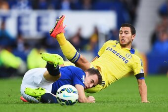 LIVERPOOL, ENGLAND - AUGUST 30:  Eden Hazard of Chelsea is tackled by Seamus Coleman of Everton during the Barclays Premier League match between Everton and Chelsea at Goodison Park on August 30, 2014 in Liverpool, England.  (Photo by Laurence Griffiths/G