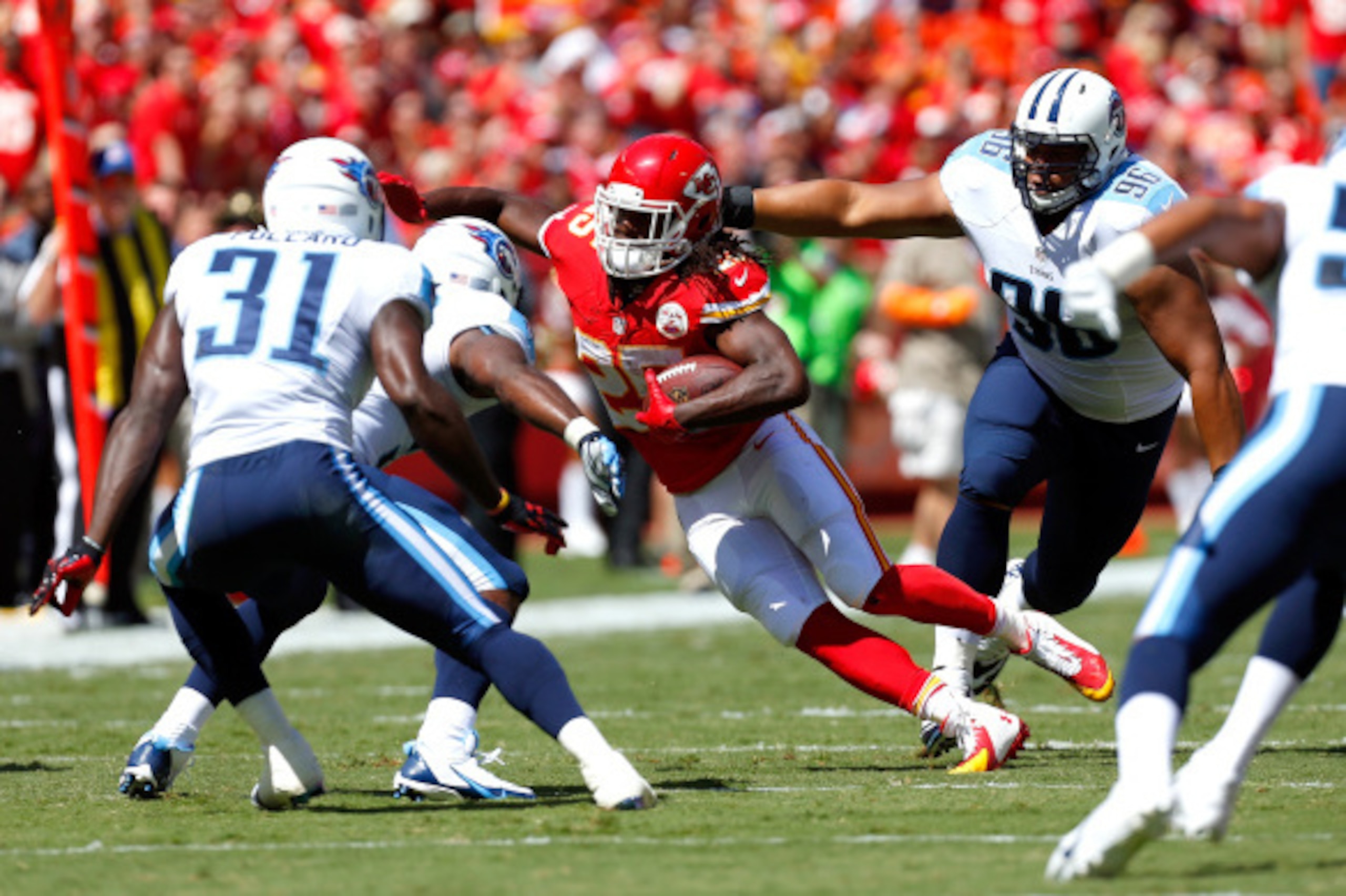 KANSAS CITY, MO - SEPTEMBER 07:  Jamaal Charles #25 of the Kansas City Chiefs runs the ball against the Tennessee Titans defense during the first half at Arrowhead Stadium on September 7, 2014 in Kansas City, Missouri.  (Photo by Wesley Hitt/Getty Images)