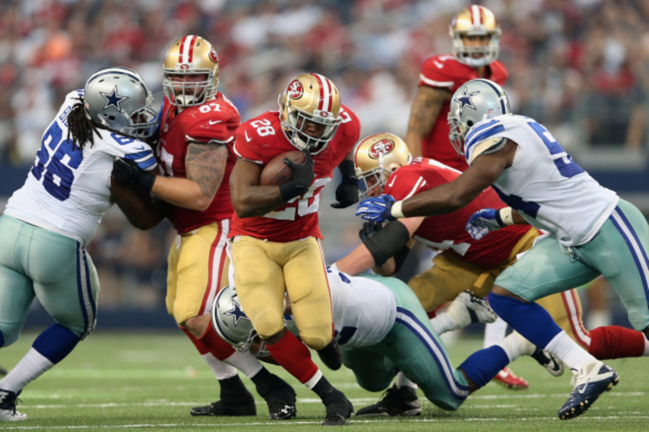 ARLINGTON, TX - SEPTEMBER 07:  Running back Carlos Hyde #28 of the San Francisco 49ers rushes the football against the Dallas Cowboys during the NFL game at AT&T Stadium on September 7, 2014 in Arlington, Texas. The 49ers defeated the Cowboys 28-17.  (Pho