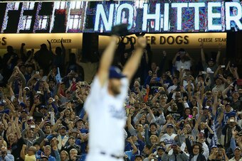 LOS ANGELES, CA - JUNE 18:  Pitcher Clayton Kershaw #22 of the Los Angeles Dodgers reacts (foreground) after pitching a no-hitter against the Colorado Rockies as fans jubilate in the background after the MLB game at Dodger Stadium on June 18, 2014 in Los