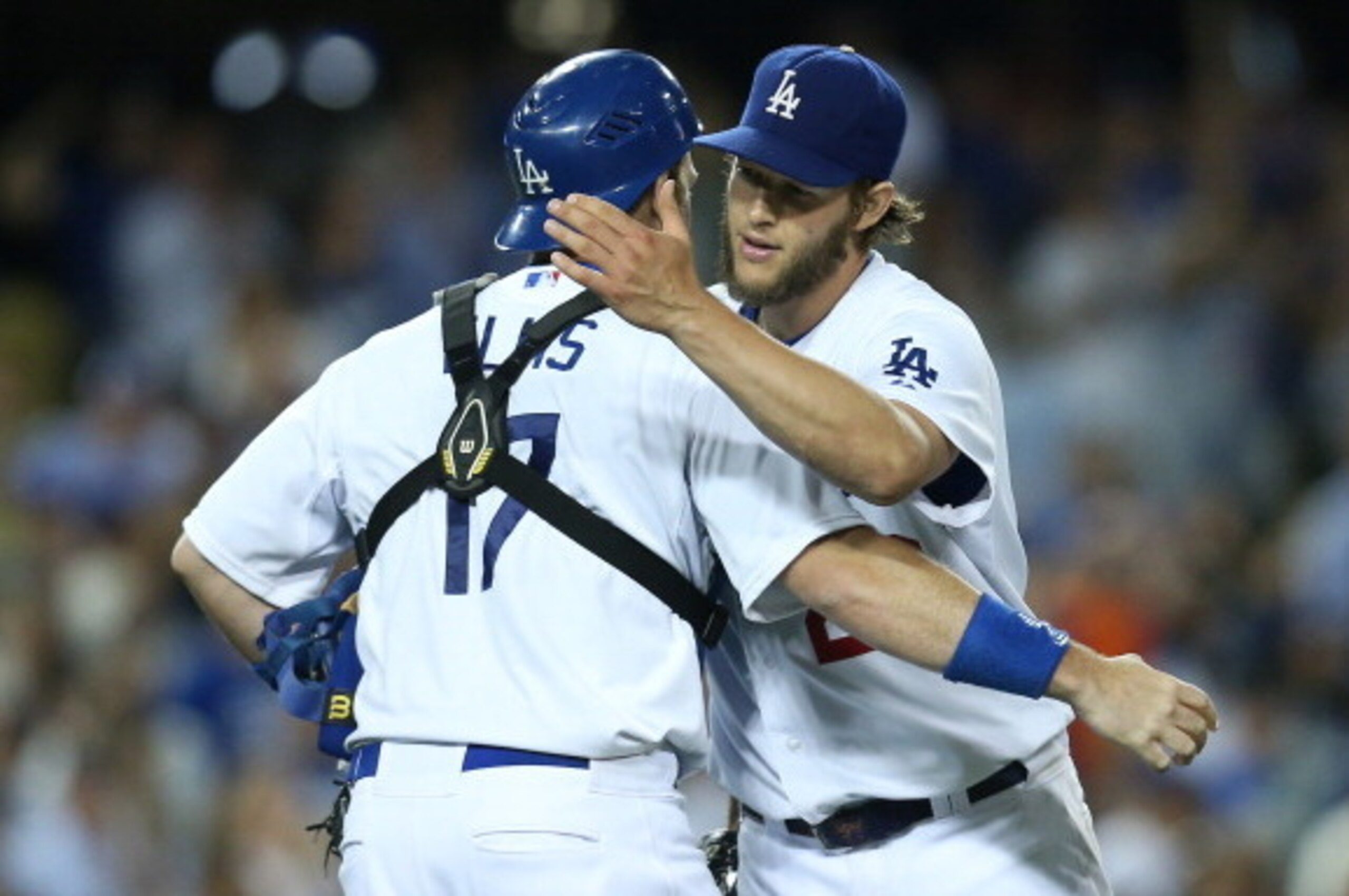 LOS ANGELES, CA - JULY 10:  Starting pitcher Clayton Kershaw #22 of the Los Angeles Dodgers embraces catcher A.J. Ellis #17 after Kershaw finished the nintth inning for a complete game victory over the San Diego Padres at Dodger Stadium on July 10, 2014 i