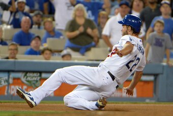 Sep 2, 2014; Los Angeles, CA, USA; Los Angeles Dodgers pitcher Clayton Kershaw (22) slides into third base in the fifth inning against the Washington Nationals at Dodger Stadium. Mandatory Credit: Kirby Lee-USA TODAY Sports