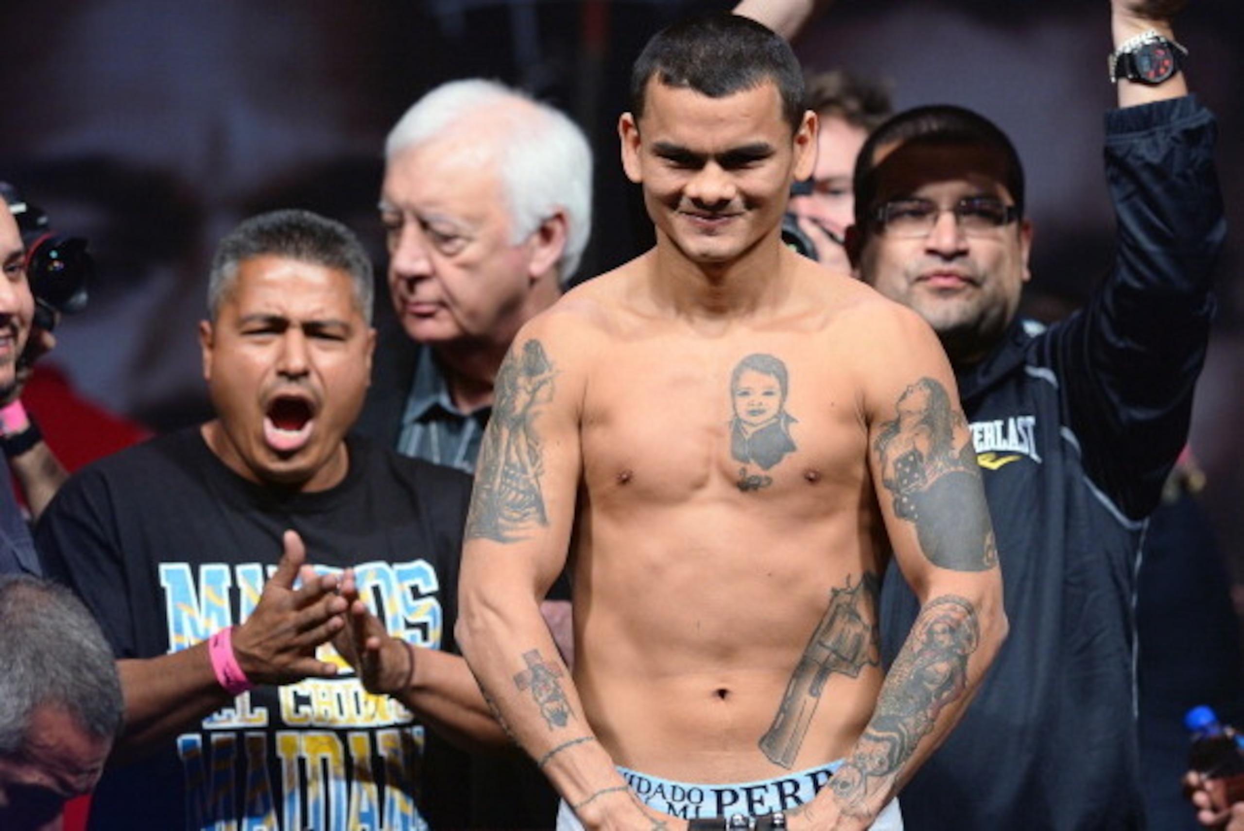 LAS VEGAS, NV - MAY 02:  WBA welterweight champion Marcos Maidana poses on the scale during his official weigh-in as his trainer Robert Garcia (L) looks on at the MGM Grand Garden Arena on May 2, 2014 in Las Vegas, Nevada. Maidana will meet WBC champion F
