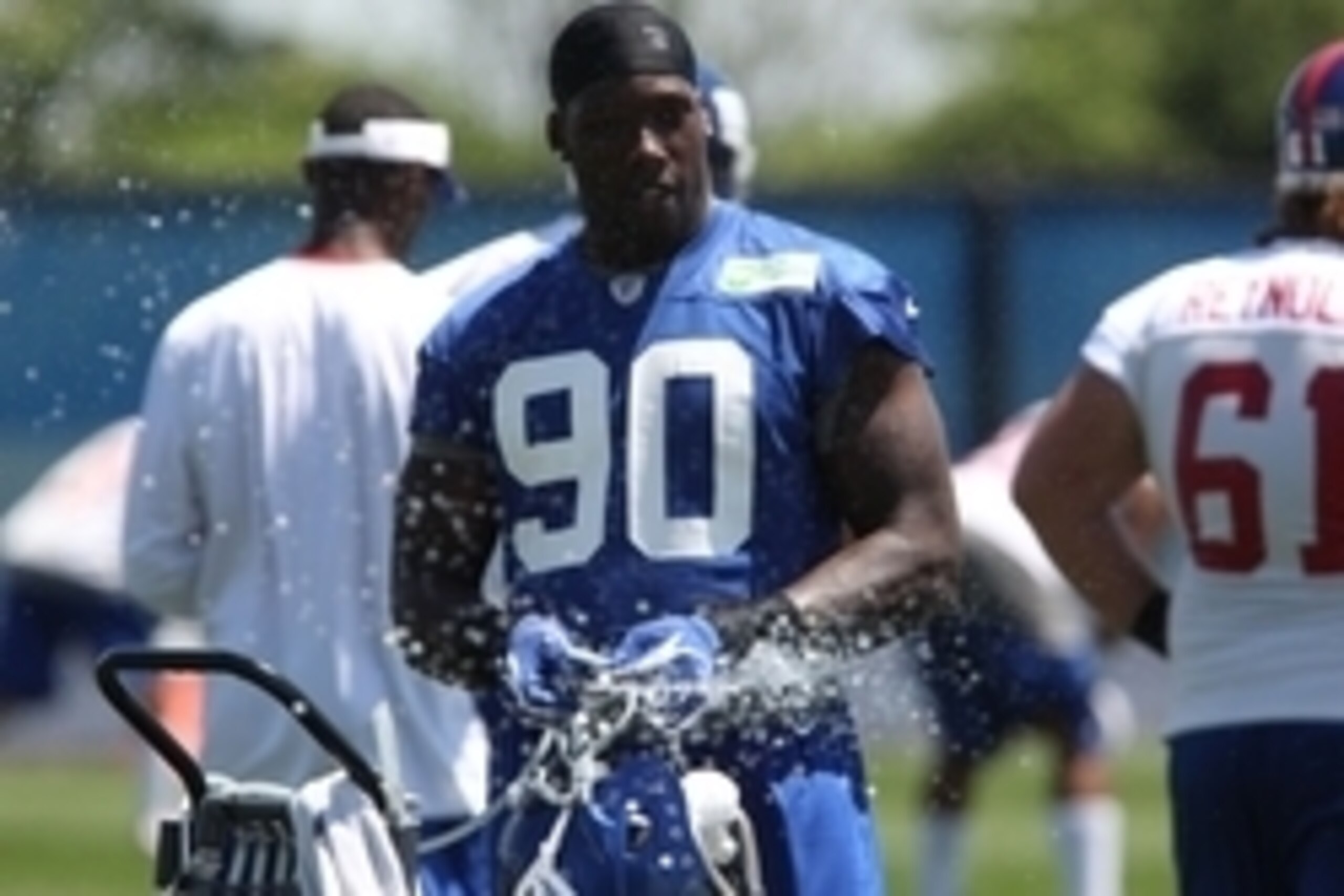 Jun 18, 2014; East Rutherford, NJ, USA; New York Giants defensive end Jason Pierre-Paul (90) cools off with a spray of water  during New York Giants mini camp at Quest Diagnostics Training Center. Mandatory Credit: Noah K. Murray-USA TODAY Sports