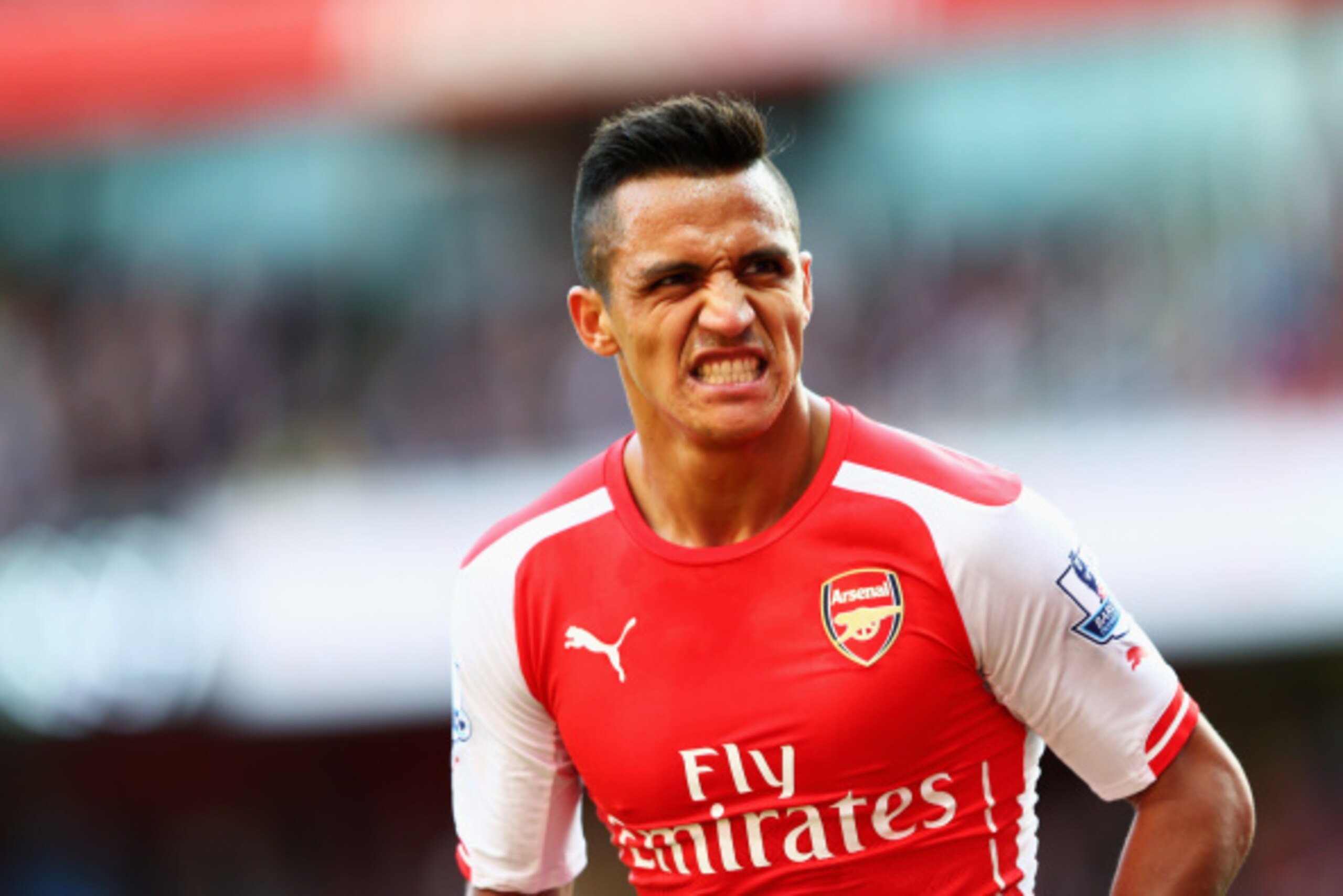 LONDON, ENGLAND - AUGUST 16: Alexis Sanchez of Arsenal grimaces during the Barclays Premier League match between Arsenal and Crystal Palace at Emirates Stadium on August 16, 2014 in London, England.  (Photo by Clive Mason/Getty Images)
